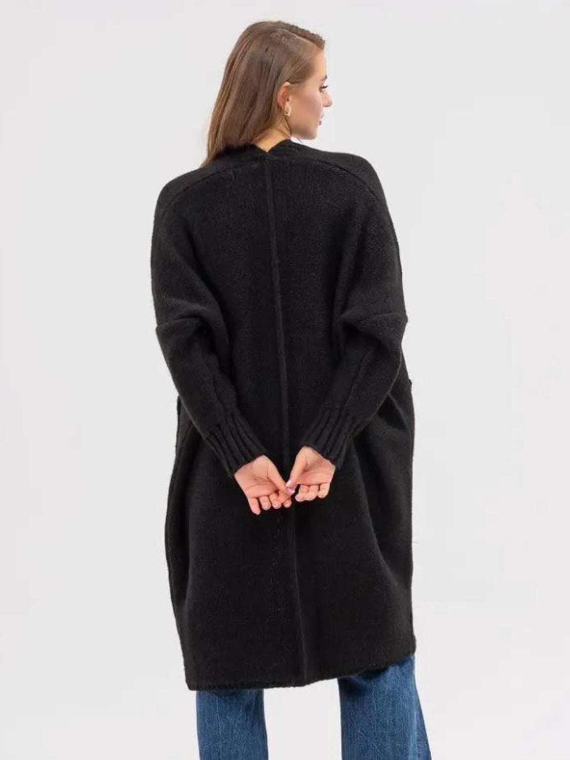 Pocketed open front long sleeve longline cardigan in black, shown from the back, moderate stretch fabric.