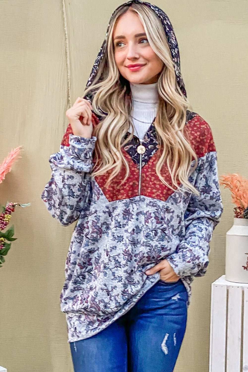 Woman wearing And The Why Printed half zip up long sleeve hoodie with floral pattern and patchwork design