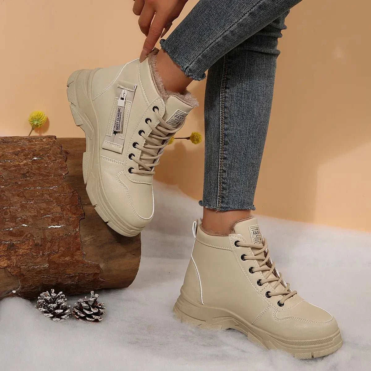 Premium lace-up combat boots in beige with fleece lining, low heels, and rugged rubber soles, styled with fitted jeans.