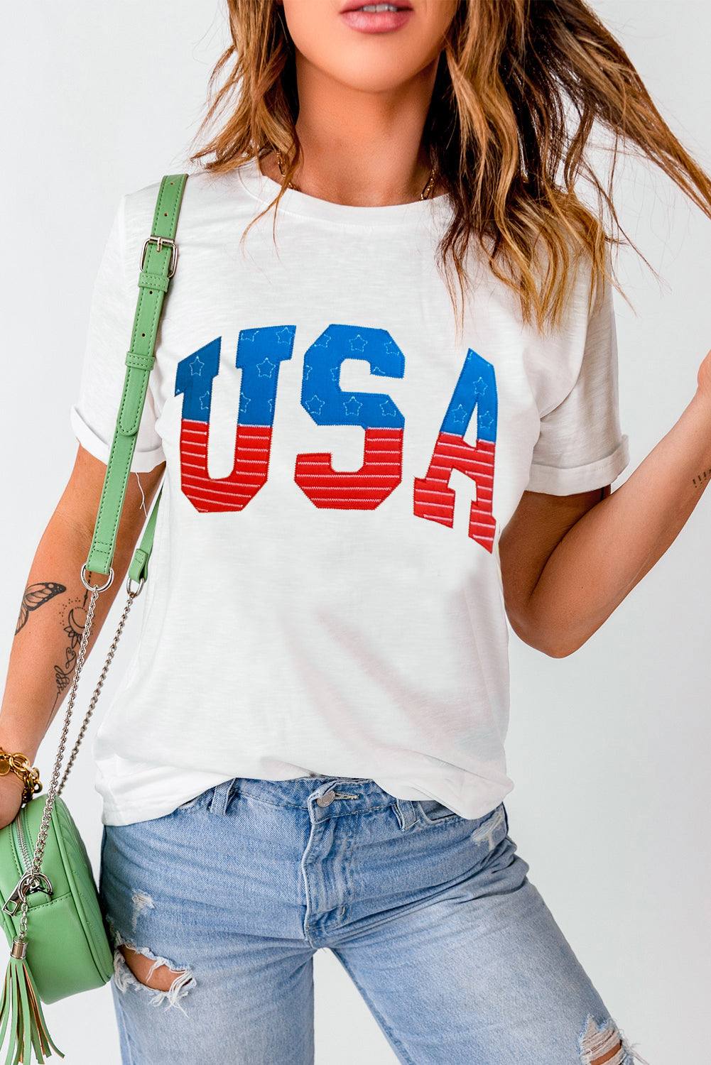 USA round neck short sleeve t-shirt with graphic print, paired with ripped jeans.