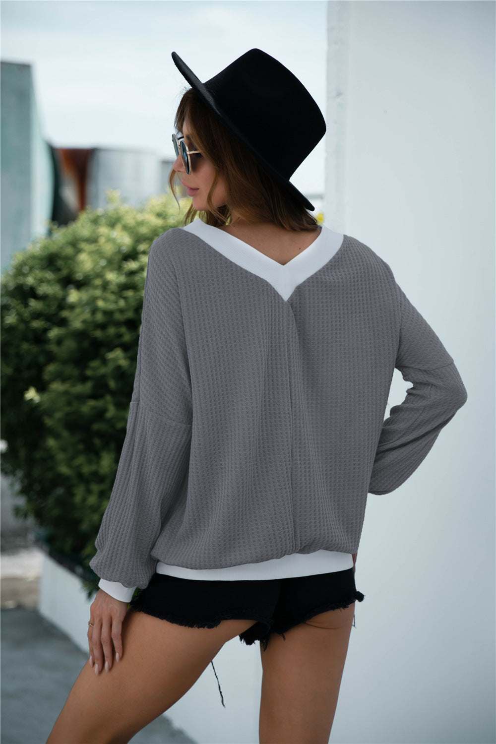Off-shoulder waffle-knit blouse with lantern sleeves in a casual style.