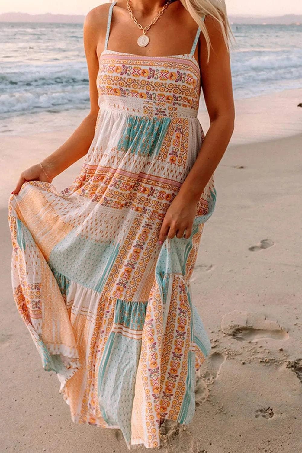 Printed square neck cami dress with colorful patterns worn on a beach.