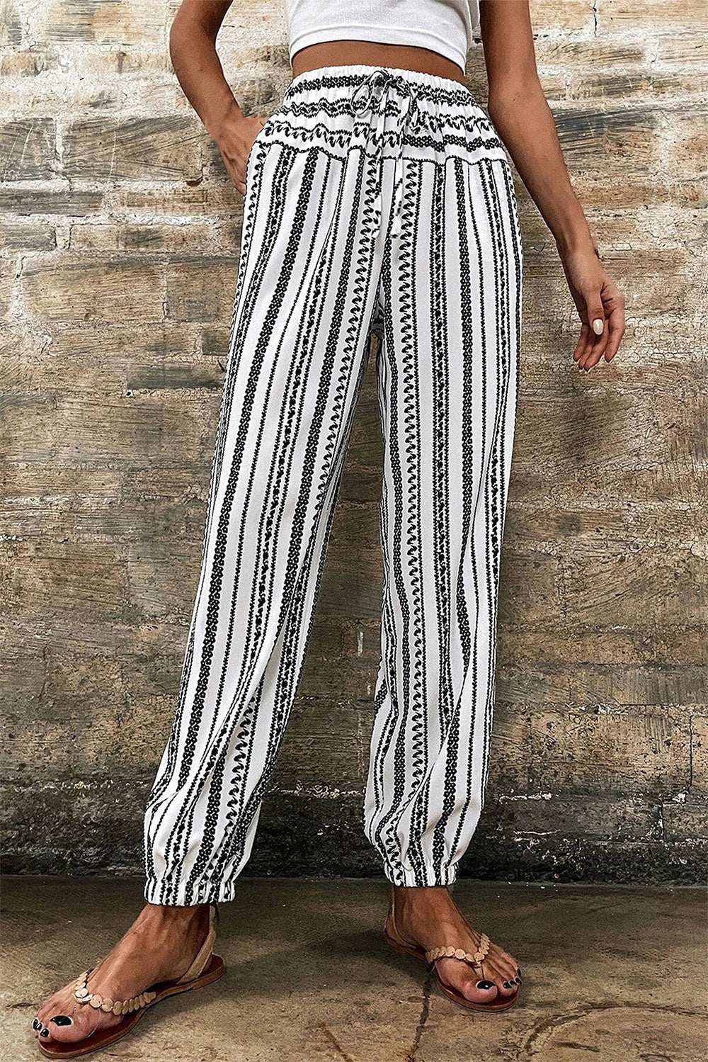 Striped printed elastic waist pants with drawstring, made from 100% polyester, machine washable.