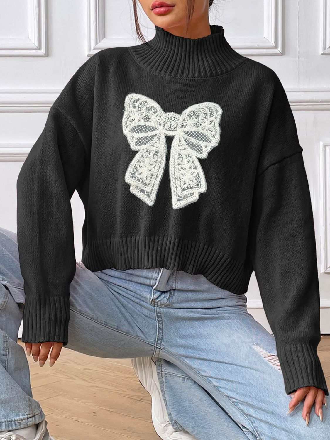 Bow Turtleneck Long Sleeve Sweater in black with white bow design.