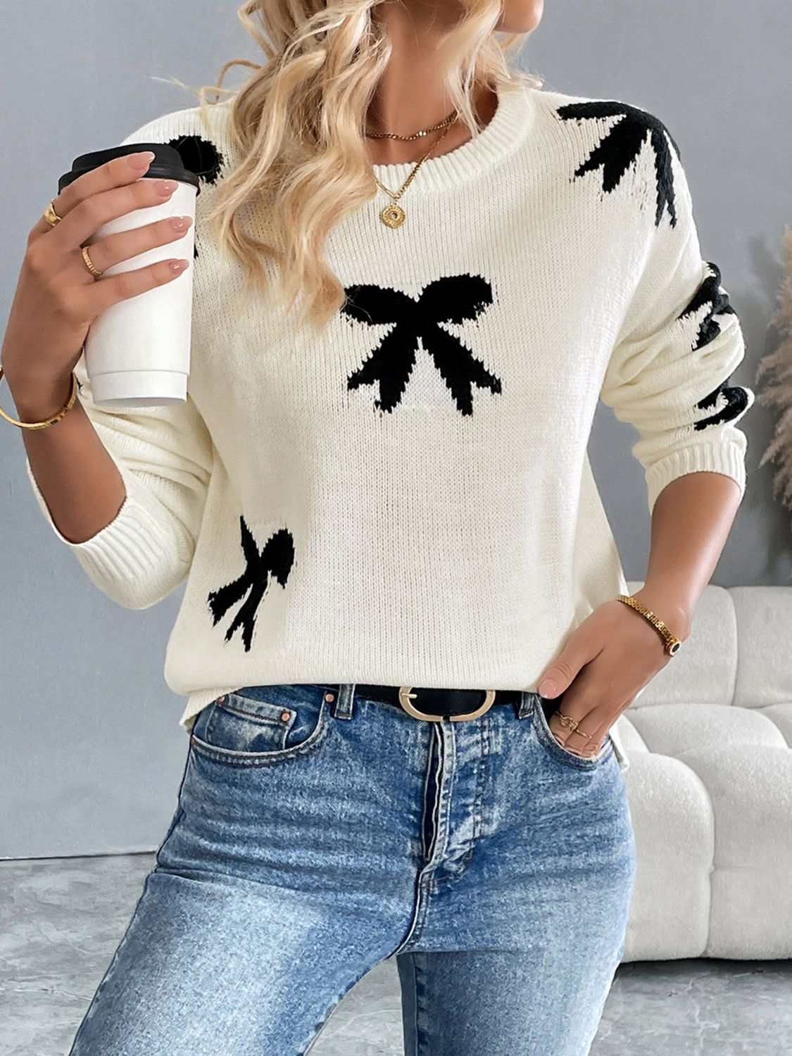 Perfee Bow Graphic Round Neck Long Sleeve Sweater in white with black bow design, moderate stretch acrylic material.