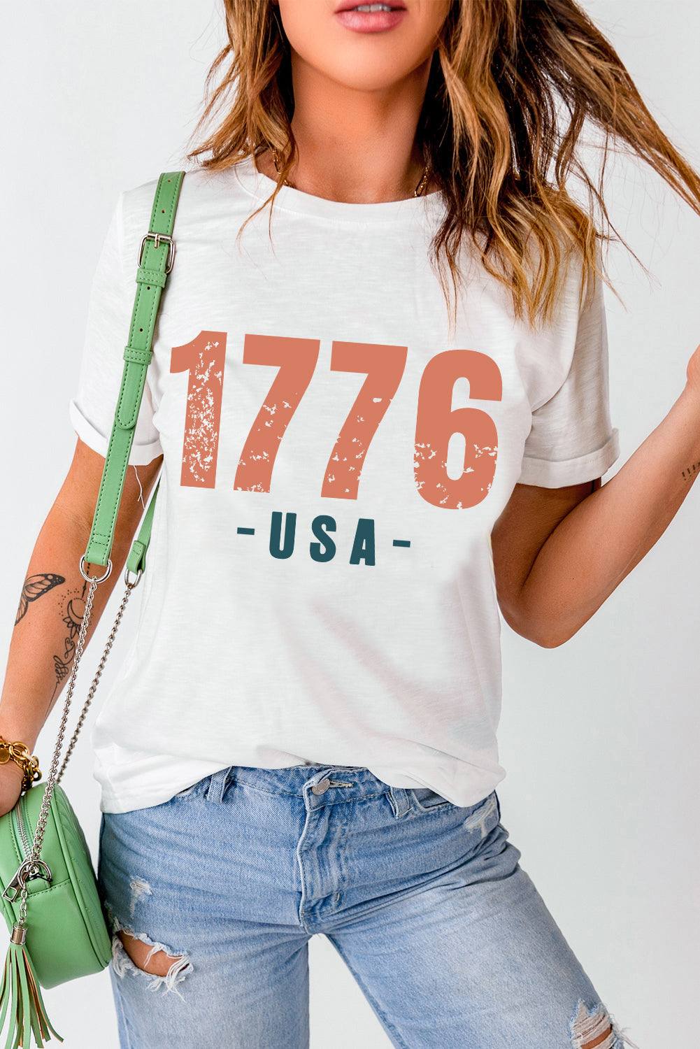 Women's graphic round neck short sleeve t-shirt with "1776 USA" print.