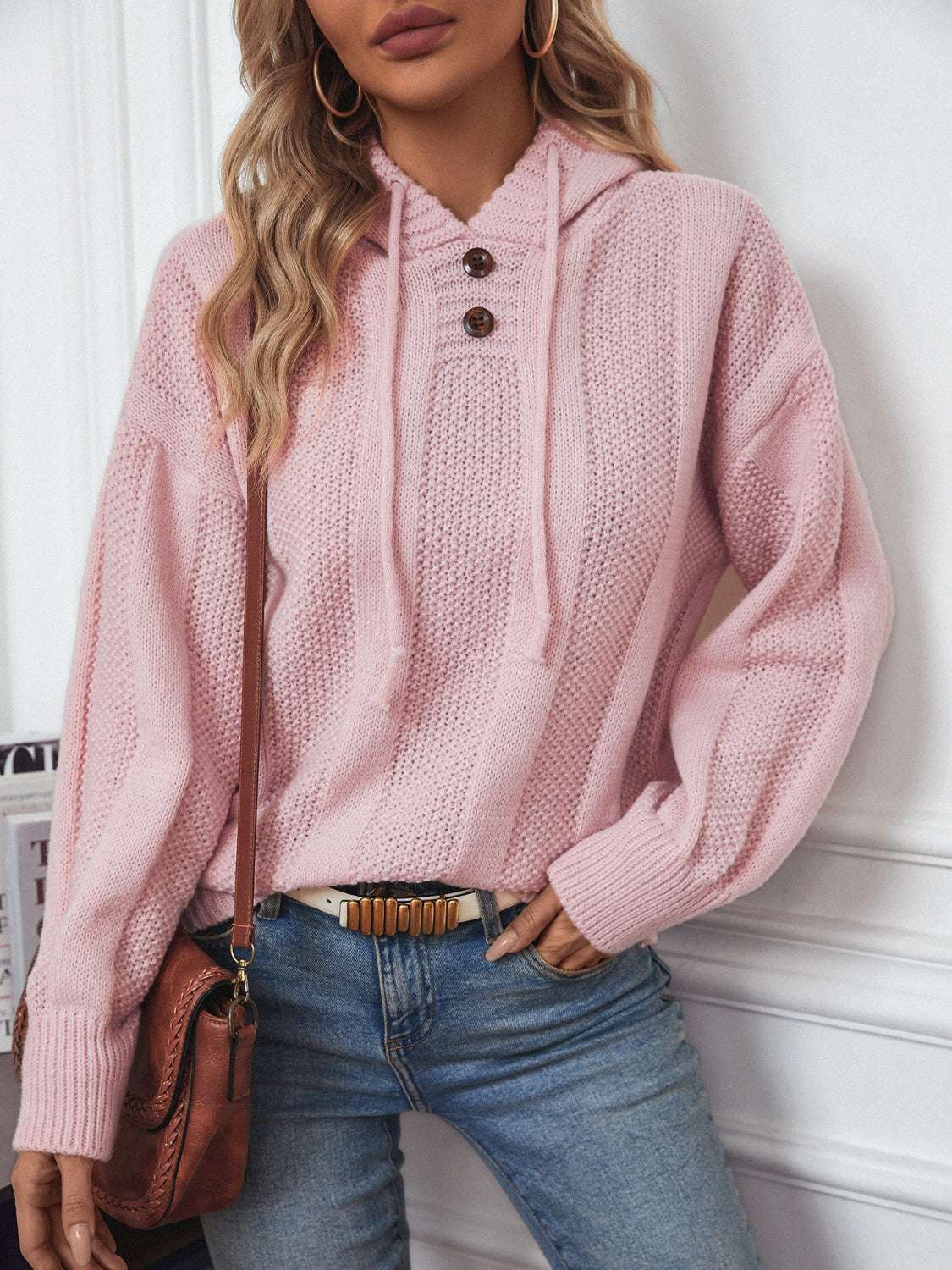 Drawstring long sleeve hooded sweater with decorative buttons in pink.