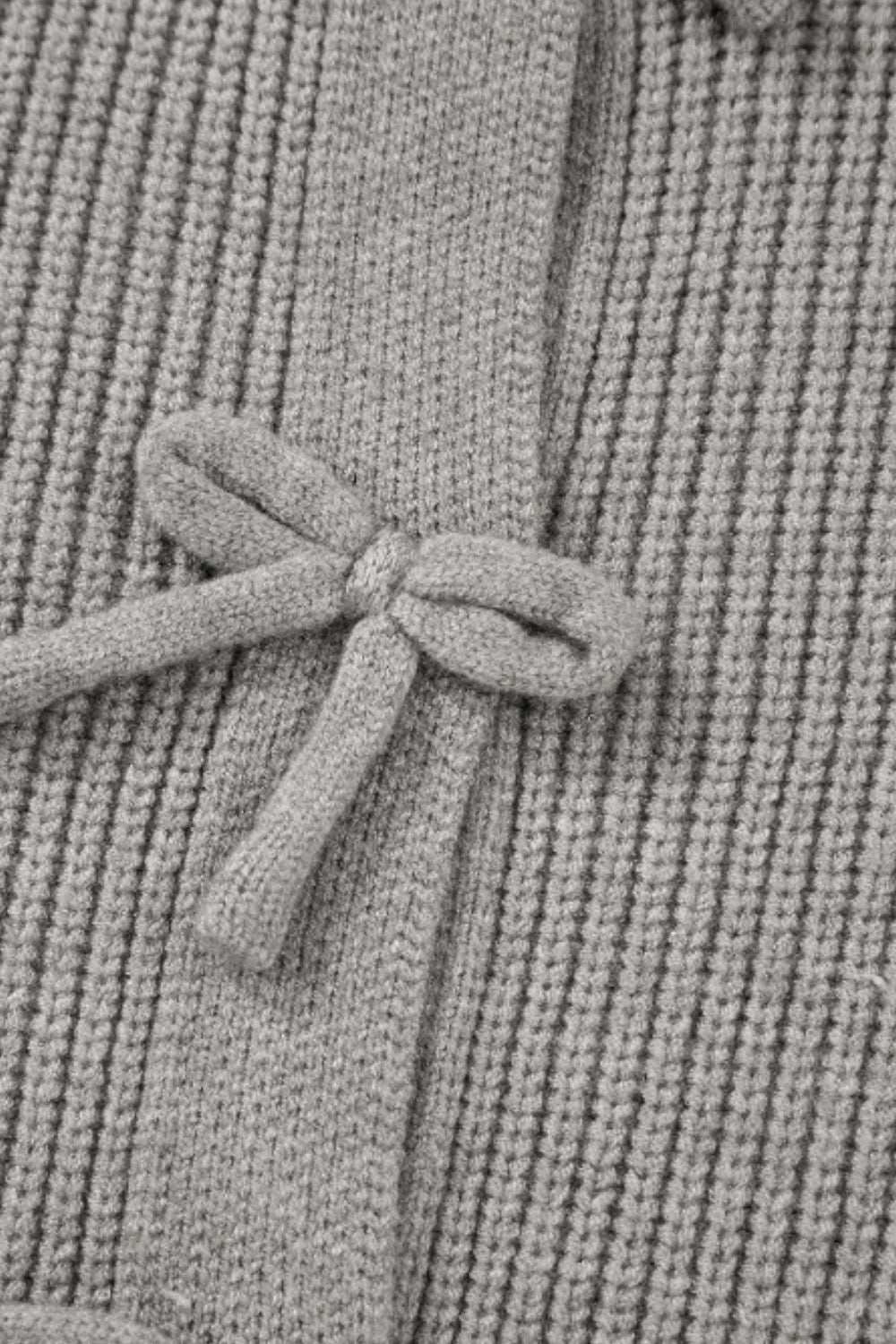 Bow detail on gray round neck long sleeve cardigan.