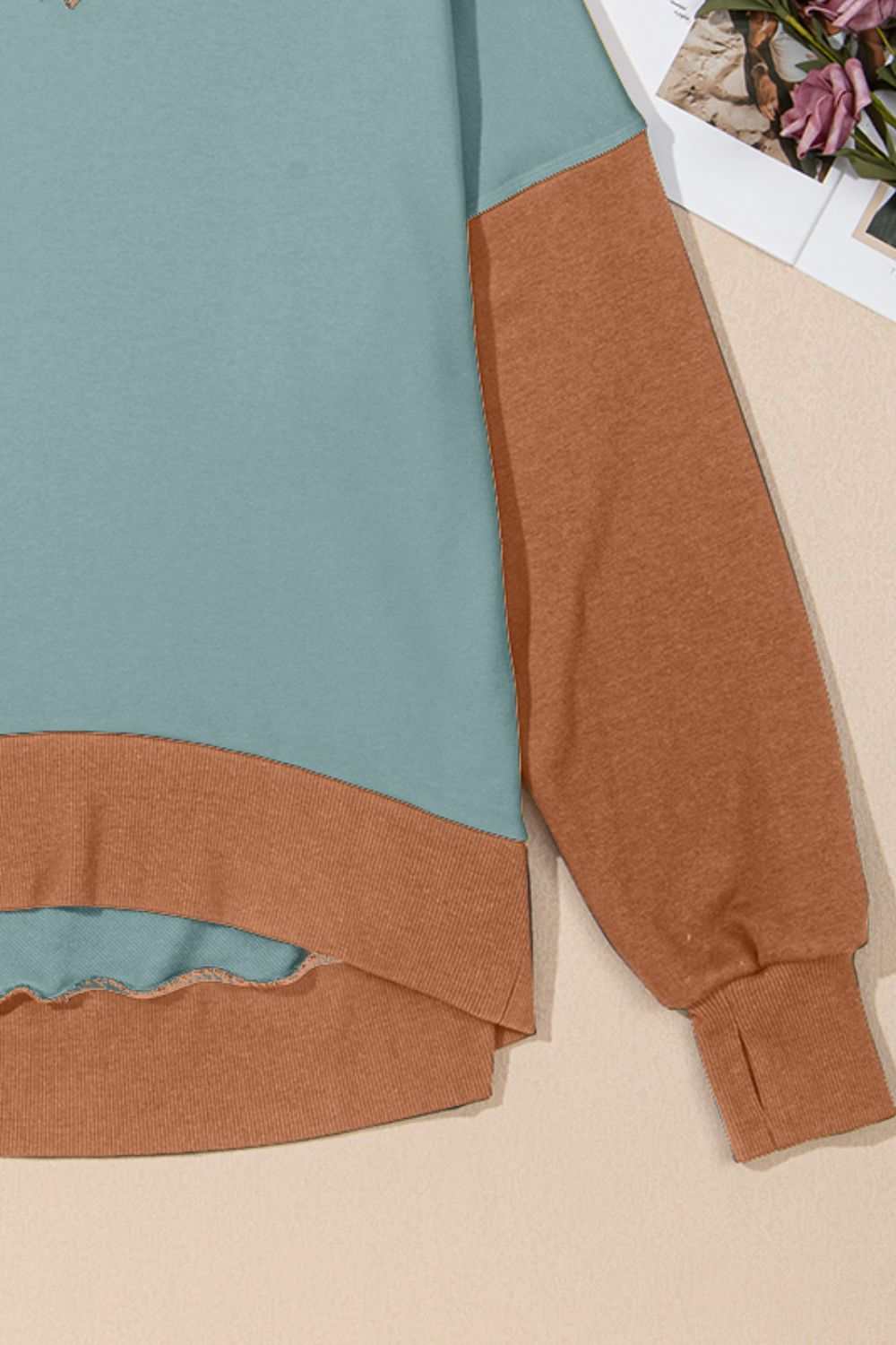 Contrast round neck long sleeve sweatshirt with brown and teal color blocking.
