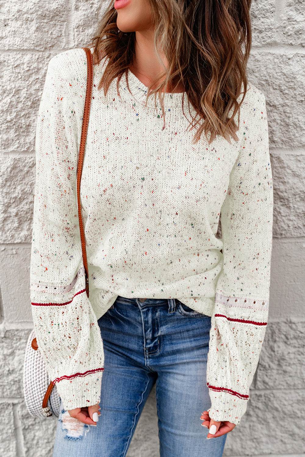 Pilling detail round neck long sleeve sweater on model, slightly stretchy, casual style.