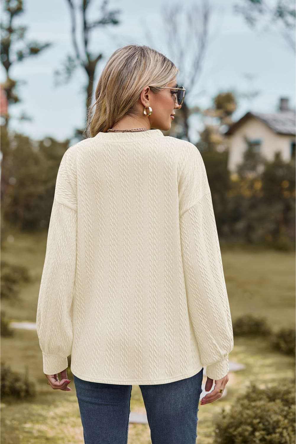 V-Neck Dropped Shoulder Blouse with long sleeves and solid pattern, worn outdoors.