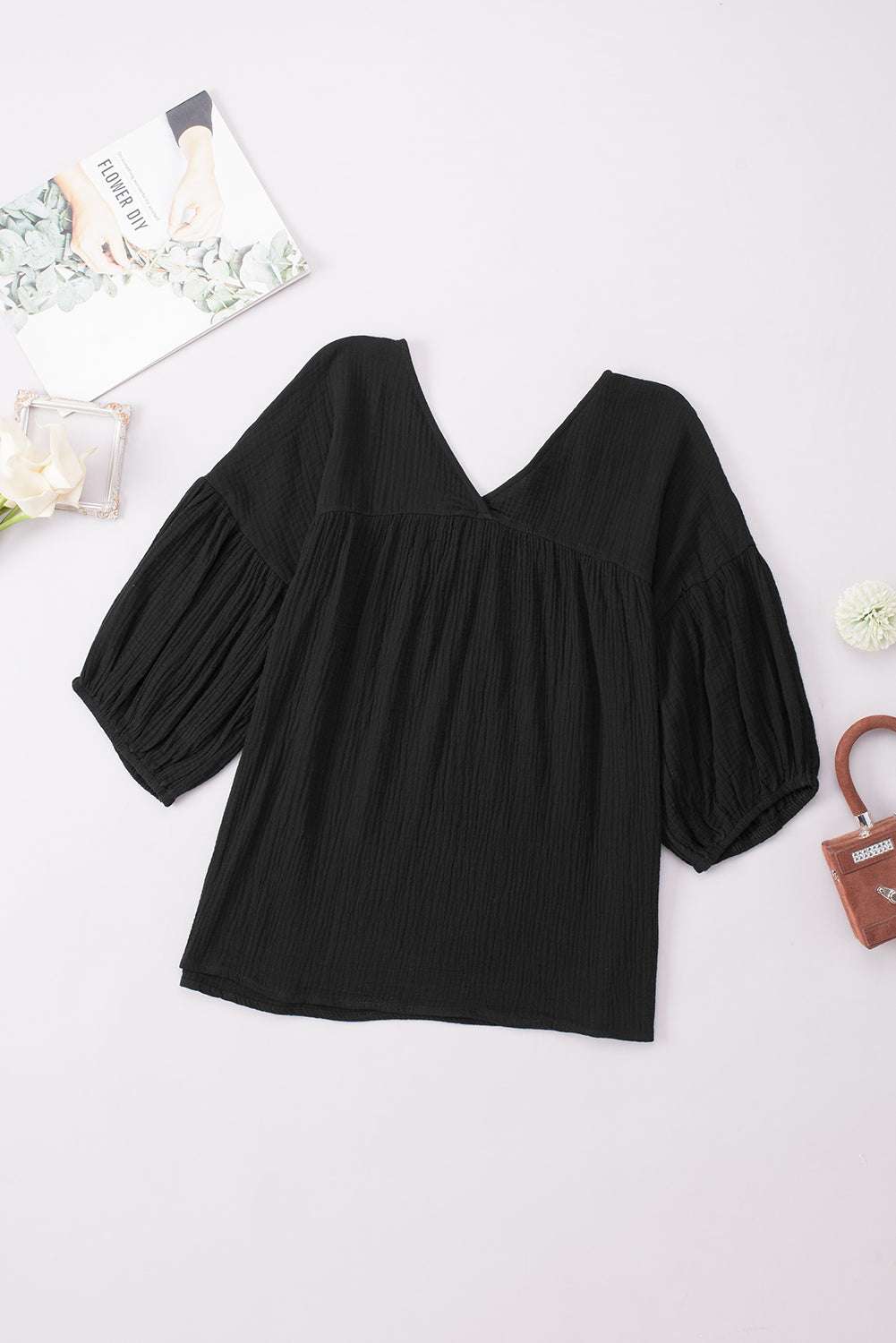 Solid black dropped shoulder V-neck blouse with long sleeves, made from 100% cotton, featuring a casual style.