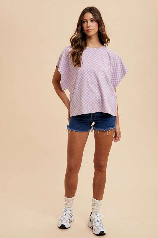 Annie Wear Checkered Round Neck Short Sleeve T-Shirt in a casual outfit with denim shorts and sneakers.