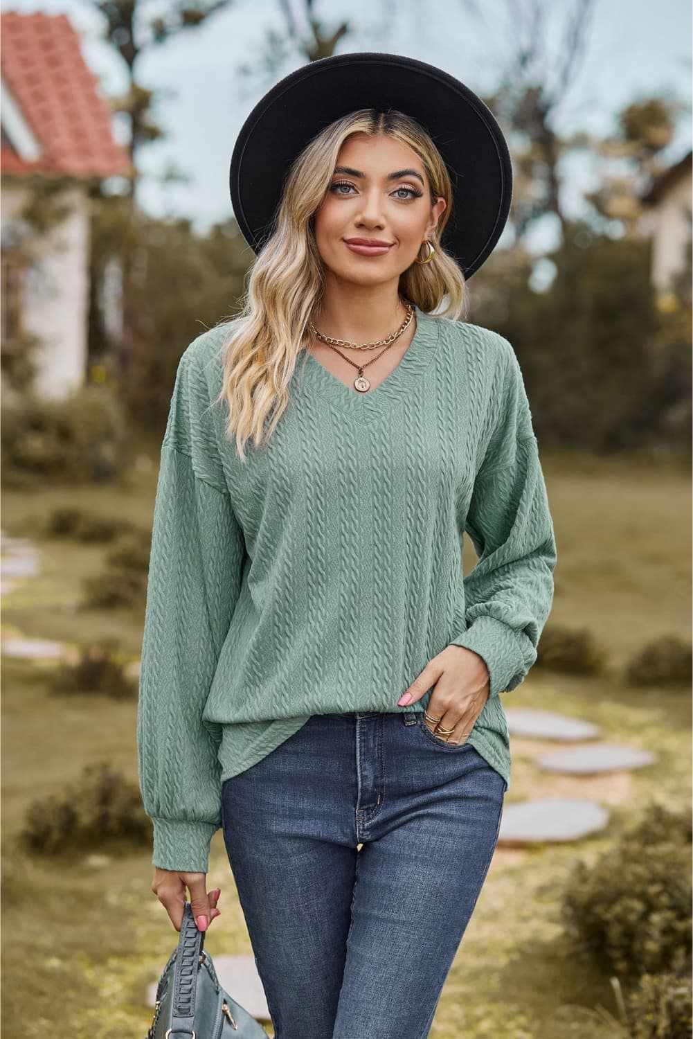 Casual V-neck dropped shoulder blouse with long sleeves in solid color.