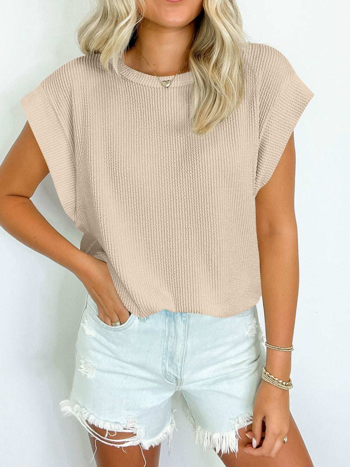 Beige Lovelet textured round neck cap sleeve blouse with slight stretch, worn with light blue distressed denim shorts