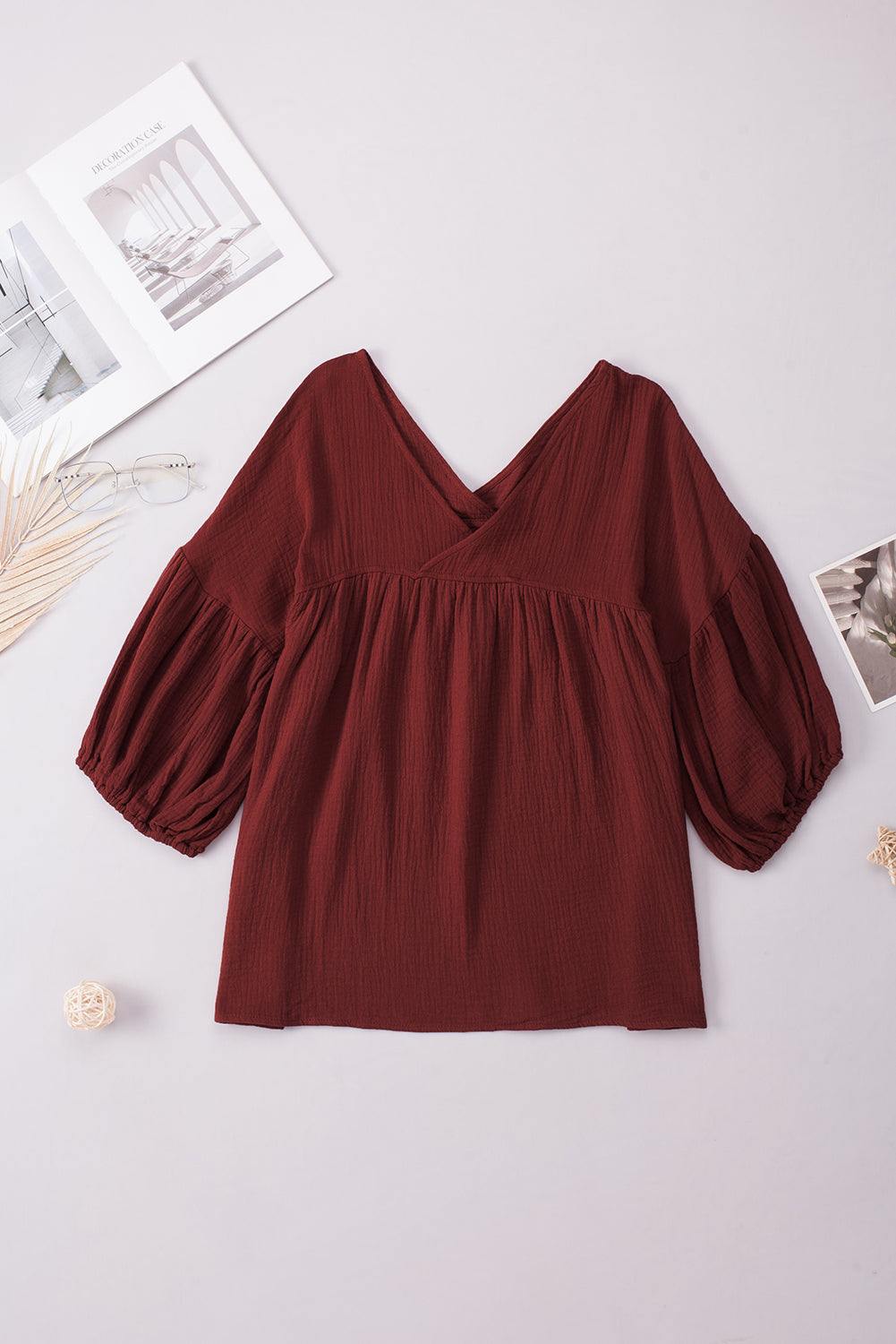 Dropped shoulder V-neck long sleeve blouse in solid burgundy color, casual style.
