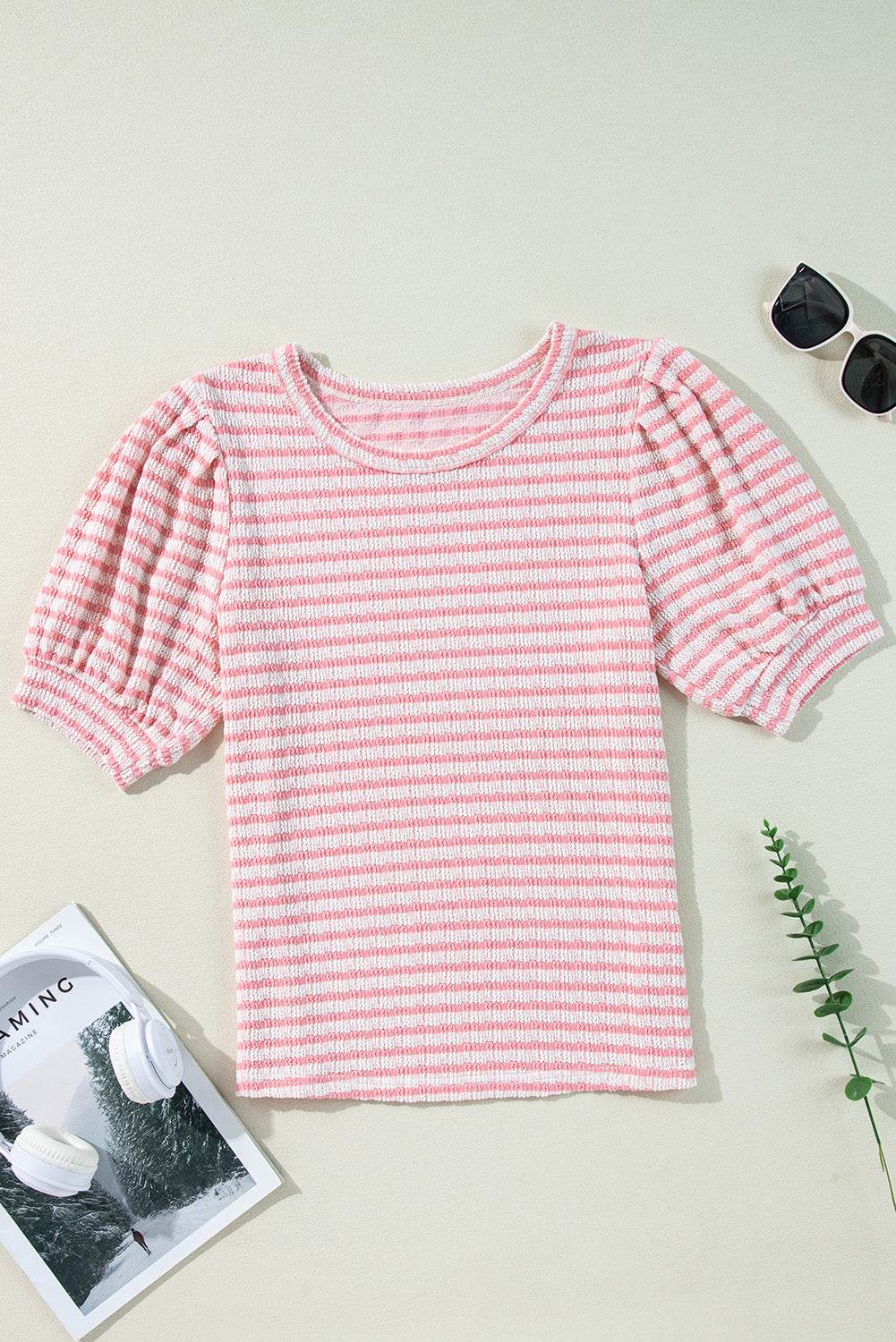Stripe textured pink puff sleeve blouse with crewneck design, slightly stretchy material.