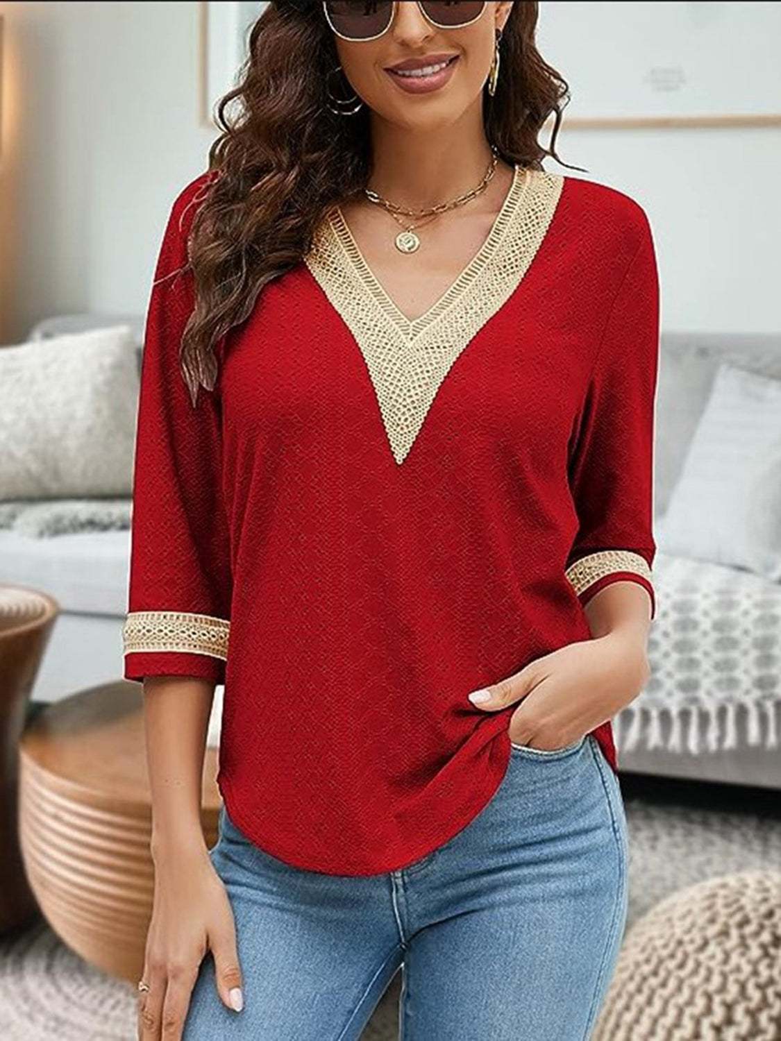 V-Neck Eyelet Blouse in red with cream trim, 3/4 sleeves, made of 100% polyester.