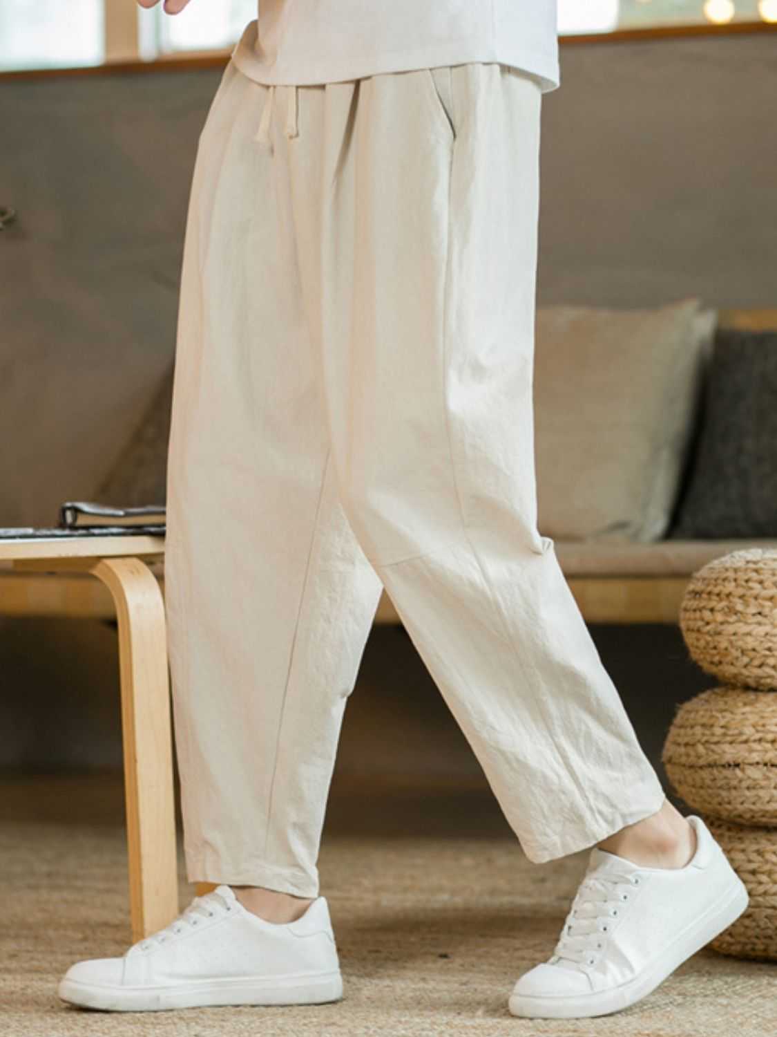 Plus size drawstring pants with pockets in beige, featuring a comfortable fit.