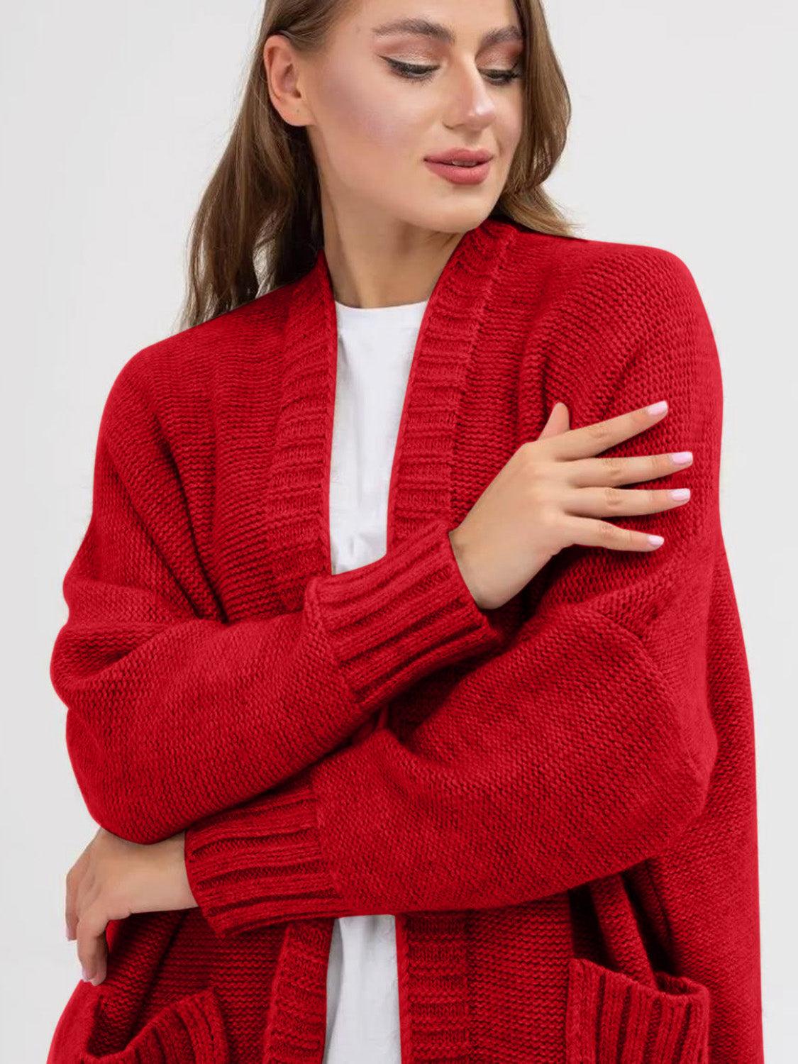 Pocketed open front long sleeve longline red cardigan with ribbed cuffs and textured material.