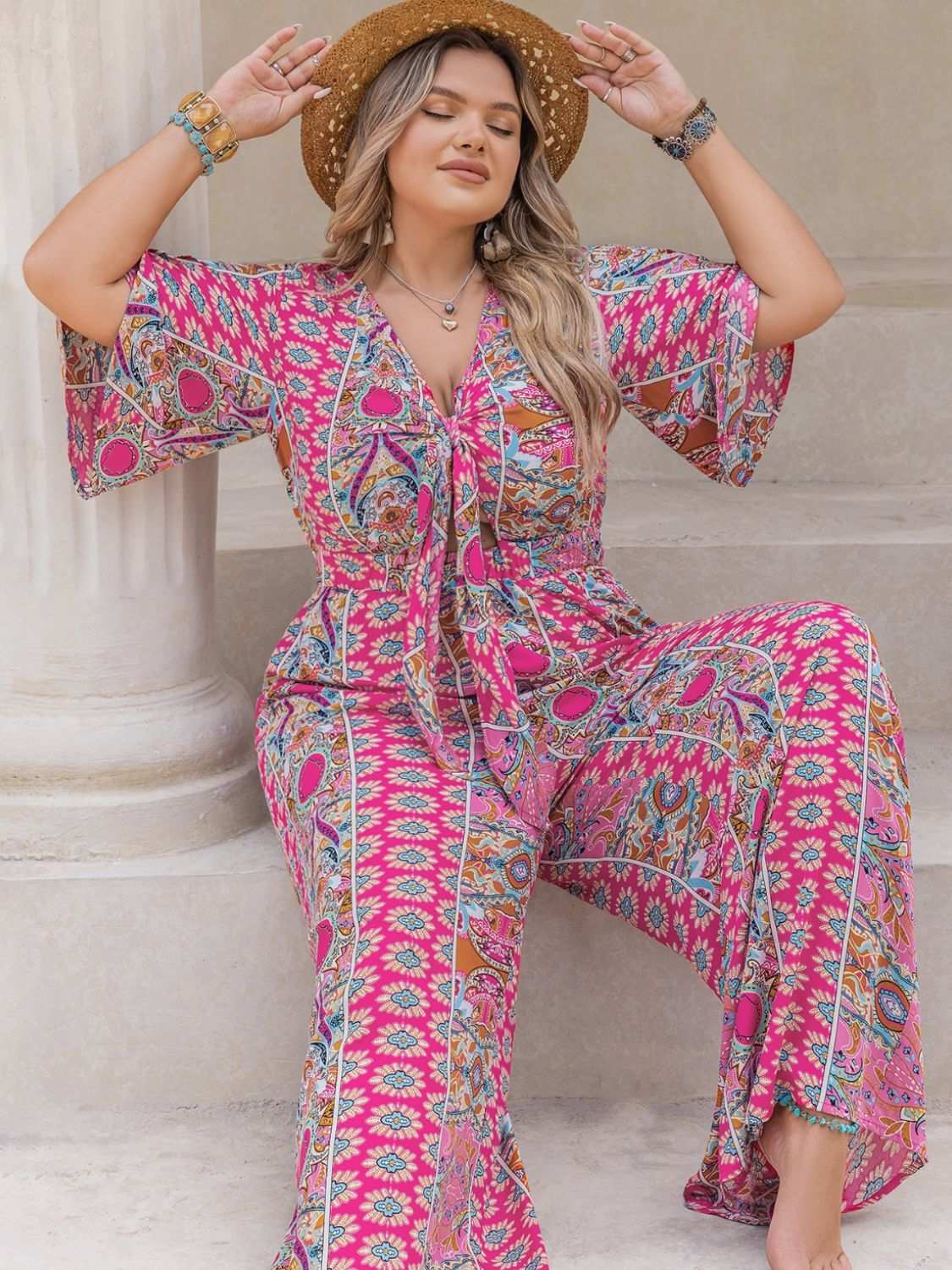 Plus size printed half sleeve wide leg jumpsuit with tie detail.