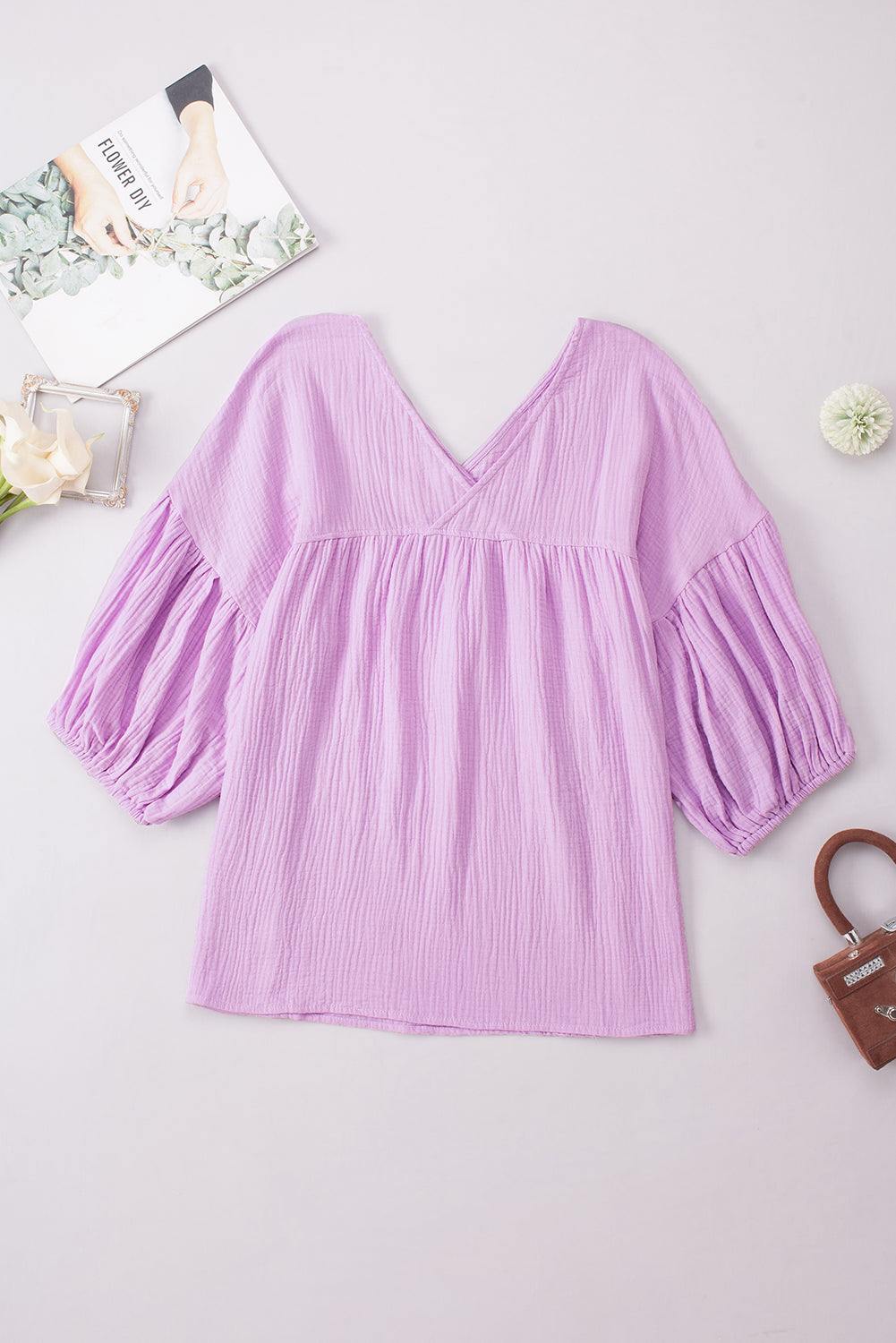 Casual solid purple V-neck blouse with dropped shoulders and long sleeves.