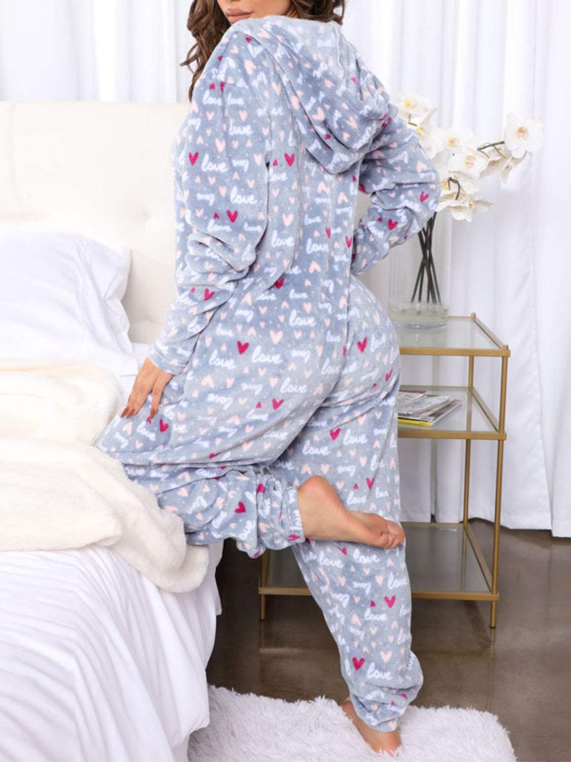 Printed zip-up long sleeve hooded lounge jumpsuit with pockets, 100% polyester.