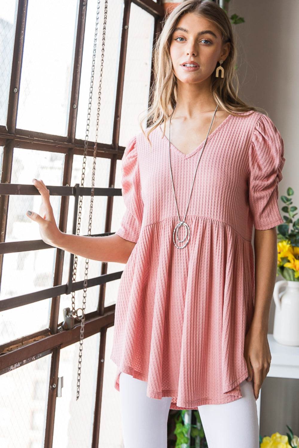 Heimish full size waffle knit V-neck babydoll top in pink with a stylish and feminine design, perfect for casual or dressed-up occasions.