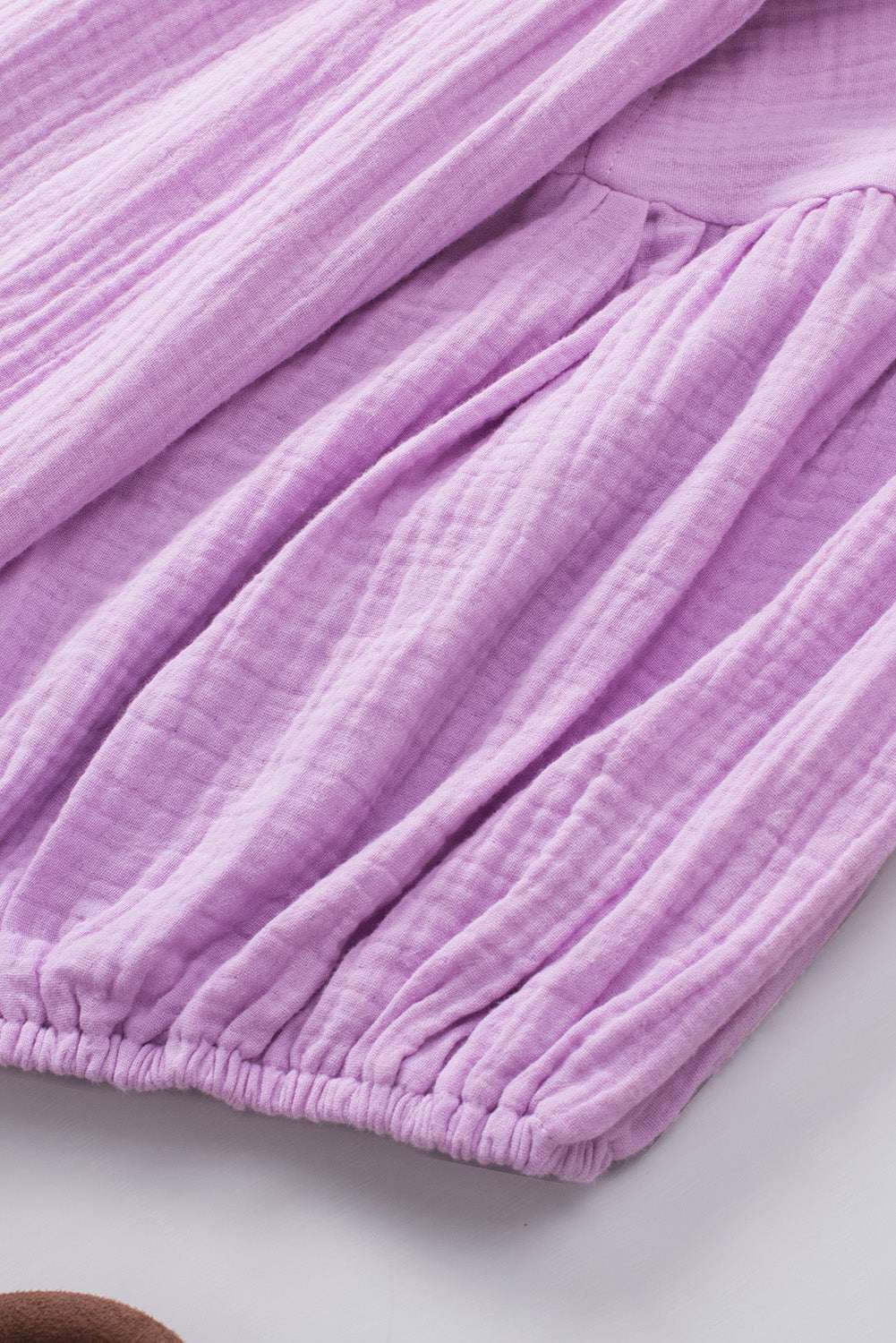 Lilac dropped shoulder V-neck blouse with long sleeves.