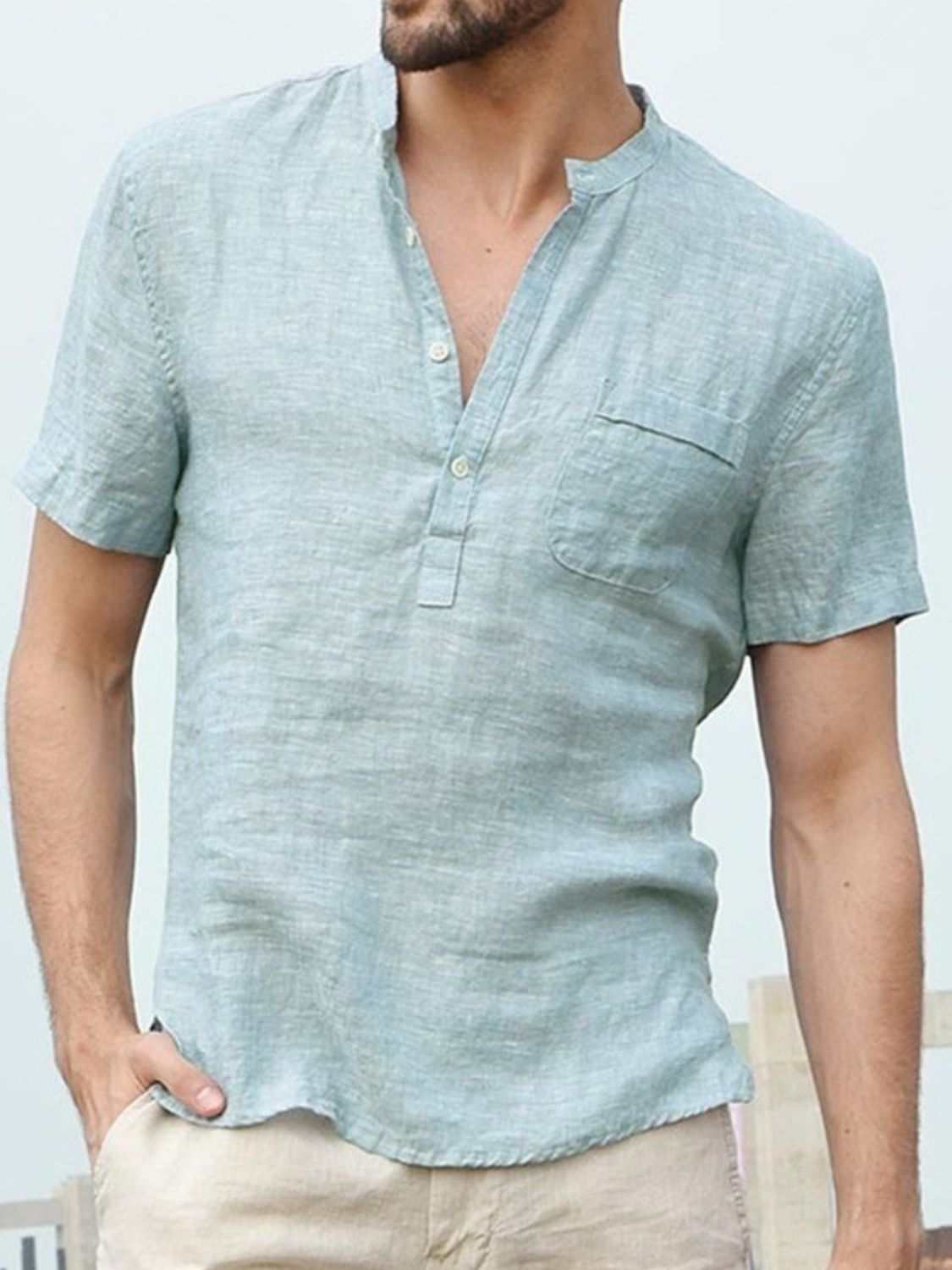 Men's full size half button short sleeve polo in light blue, made from 70% polyester and 30% flax.