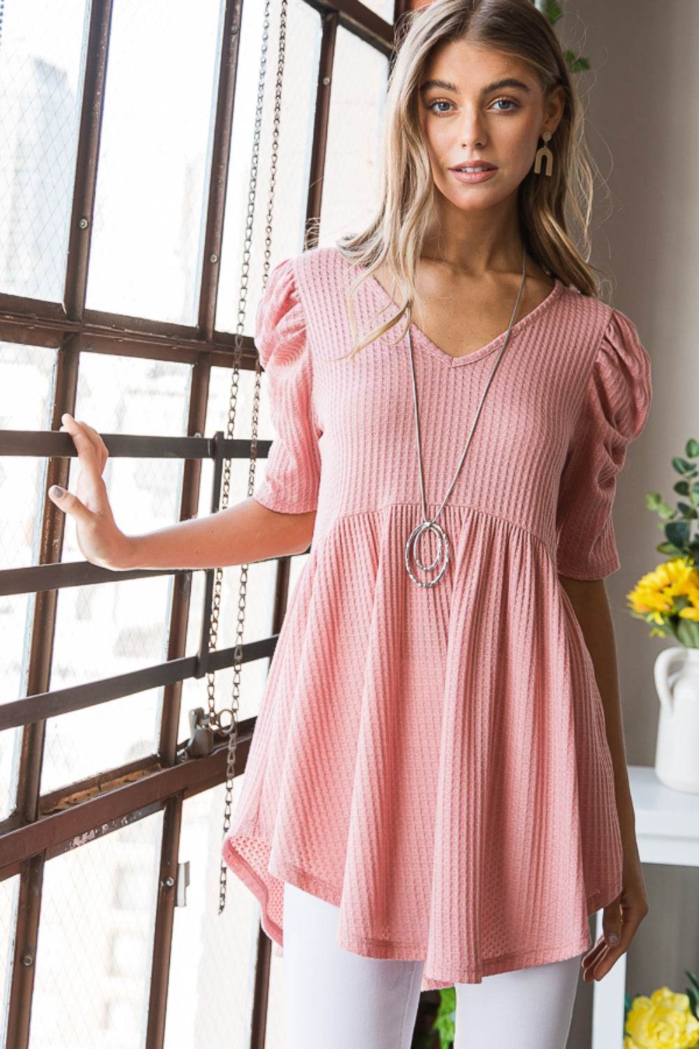 Heimish full size waffle knit V-neck babydoll top in pink, featuring a flattering babydoll style and stretchy fabric, perfect for casual or dressy occasions.