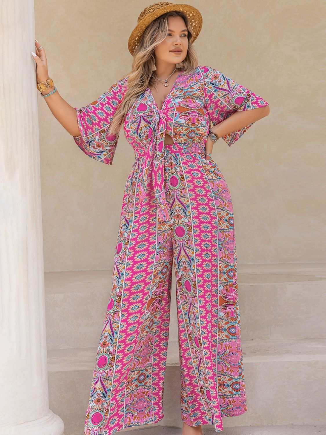 Plus size printed half sleeve wide leg jumpsuit.