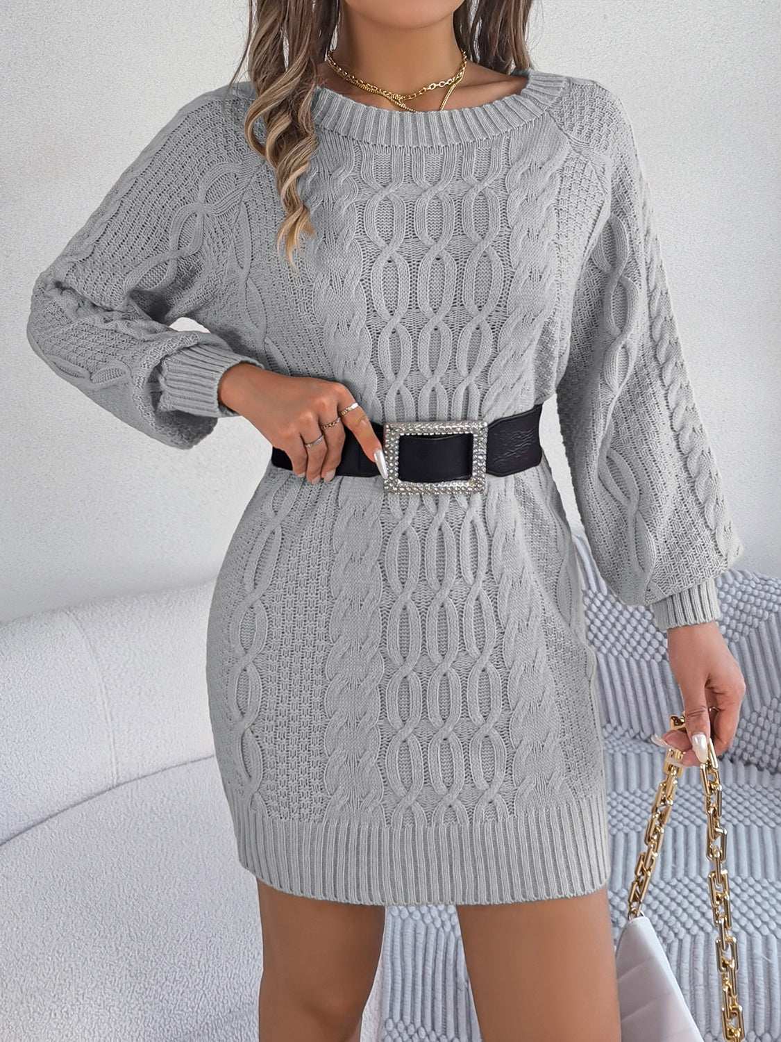 Cable-knit round neck sweater dress with moderate stretch in acrylic material.