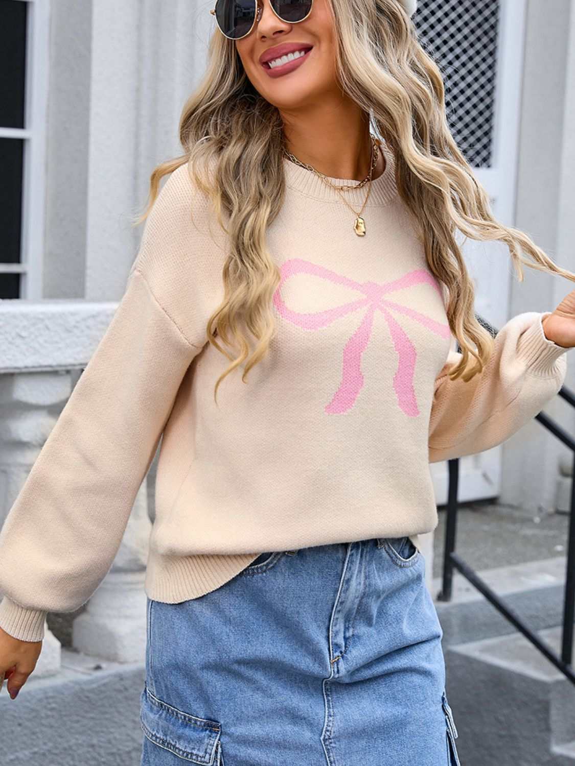 Angel Wings Bow Graphic Round Neck Long Sleeve Sweater in cream with pink bow design.