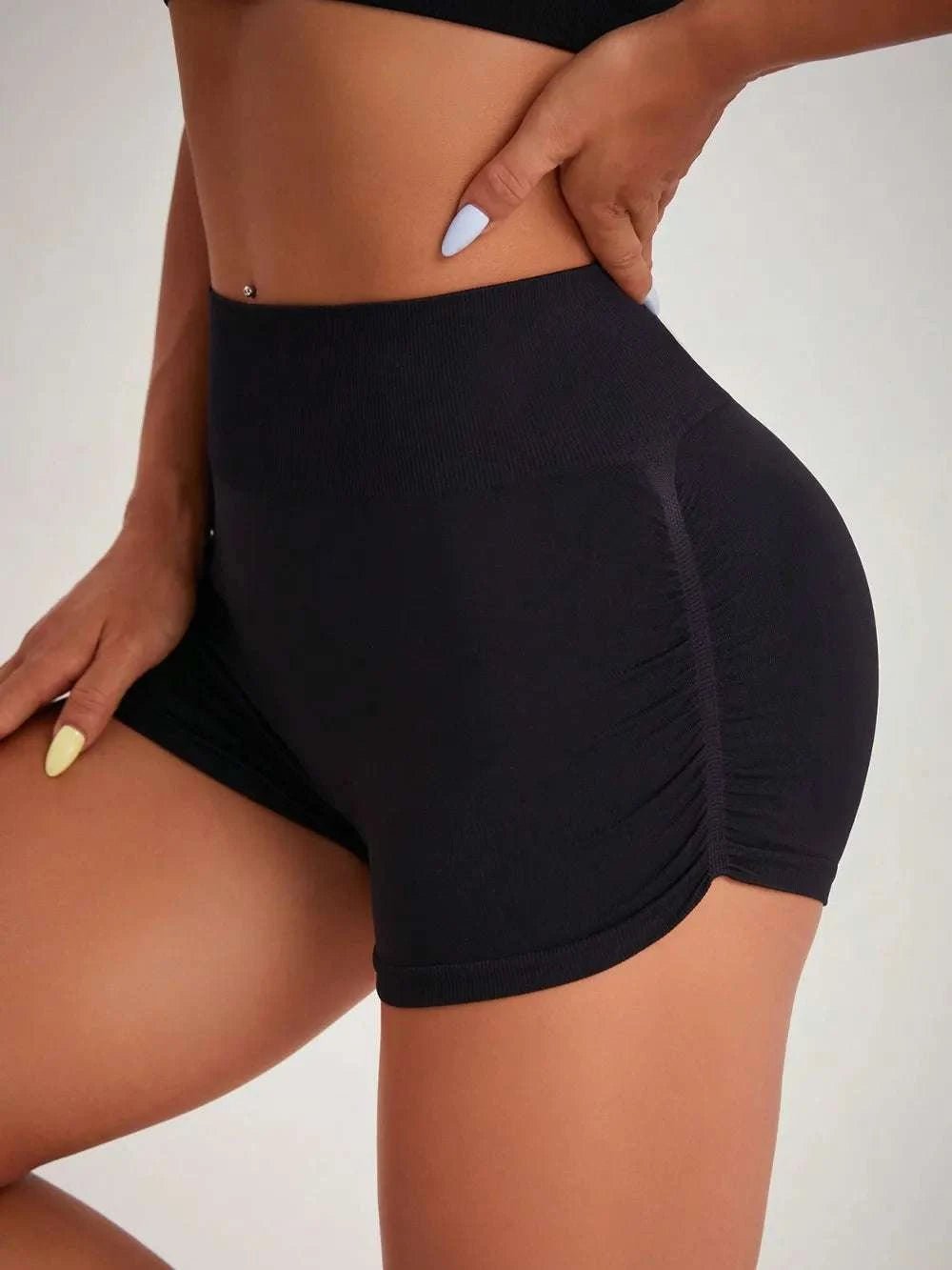 High waist active shorts in black with moderate stretch, highlighting sleek fit and basic style.