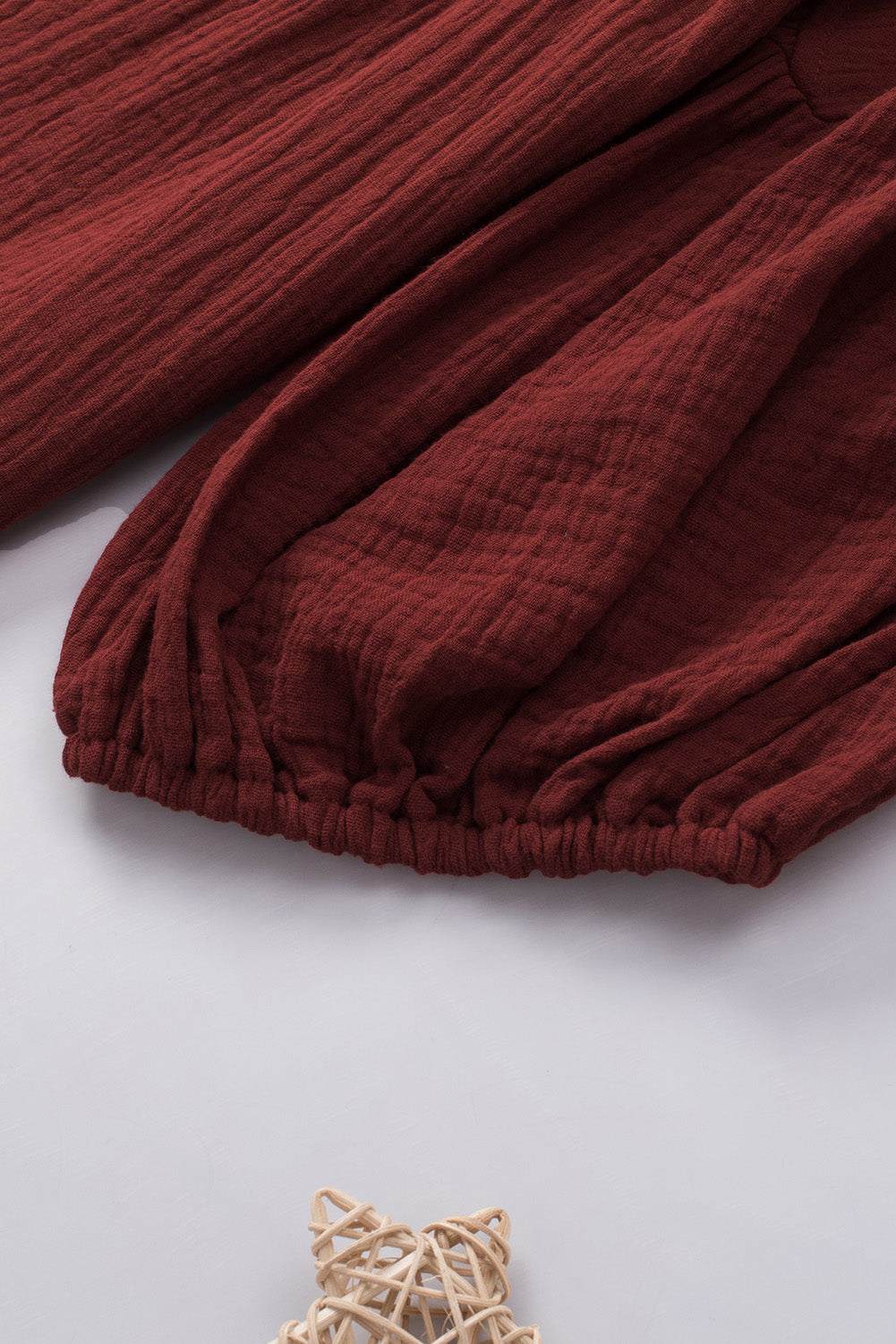 Dropped shoulder V-neck blouse in solid color with long sleeves and casual style.