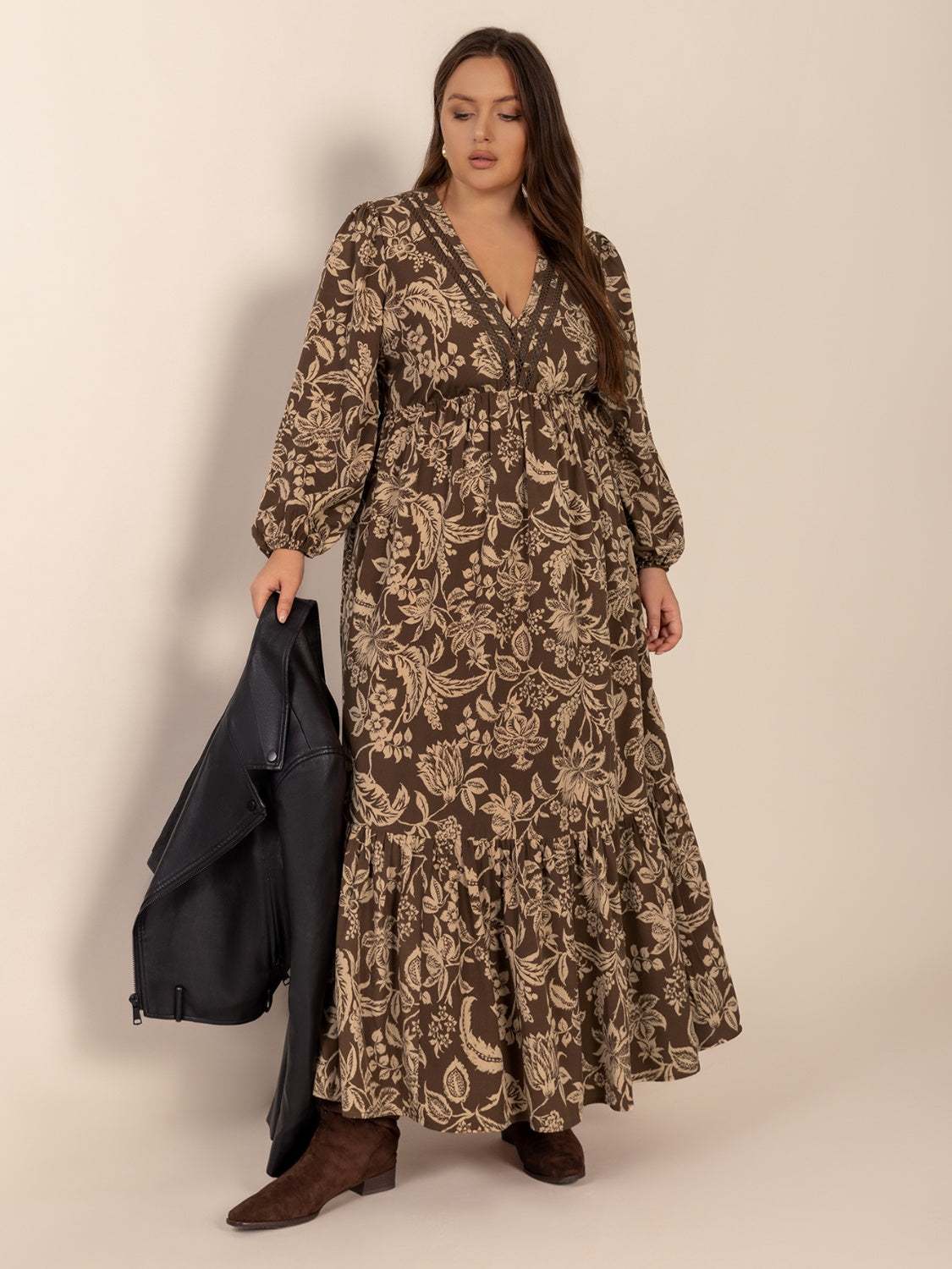 Plus size printed V-neck balloon sleeve maxi dress in brown with floral pattern.