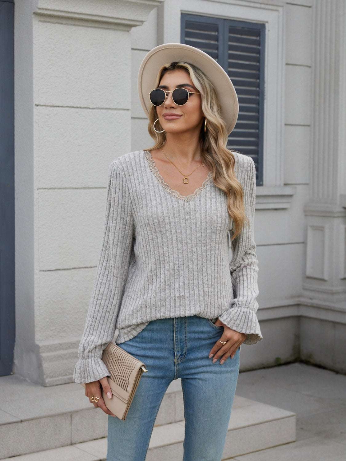 Lace Detail V-Neck Long Sleeve T-Shirt with ruffled cuffs, slightly stretchy polyester fabric, worn by a woman in jeans and a hat.