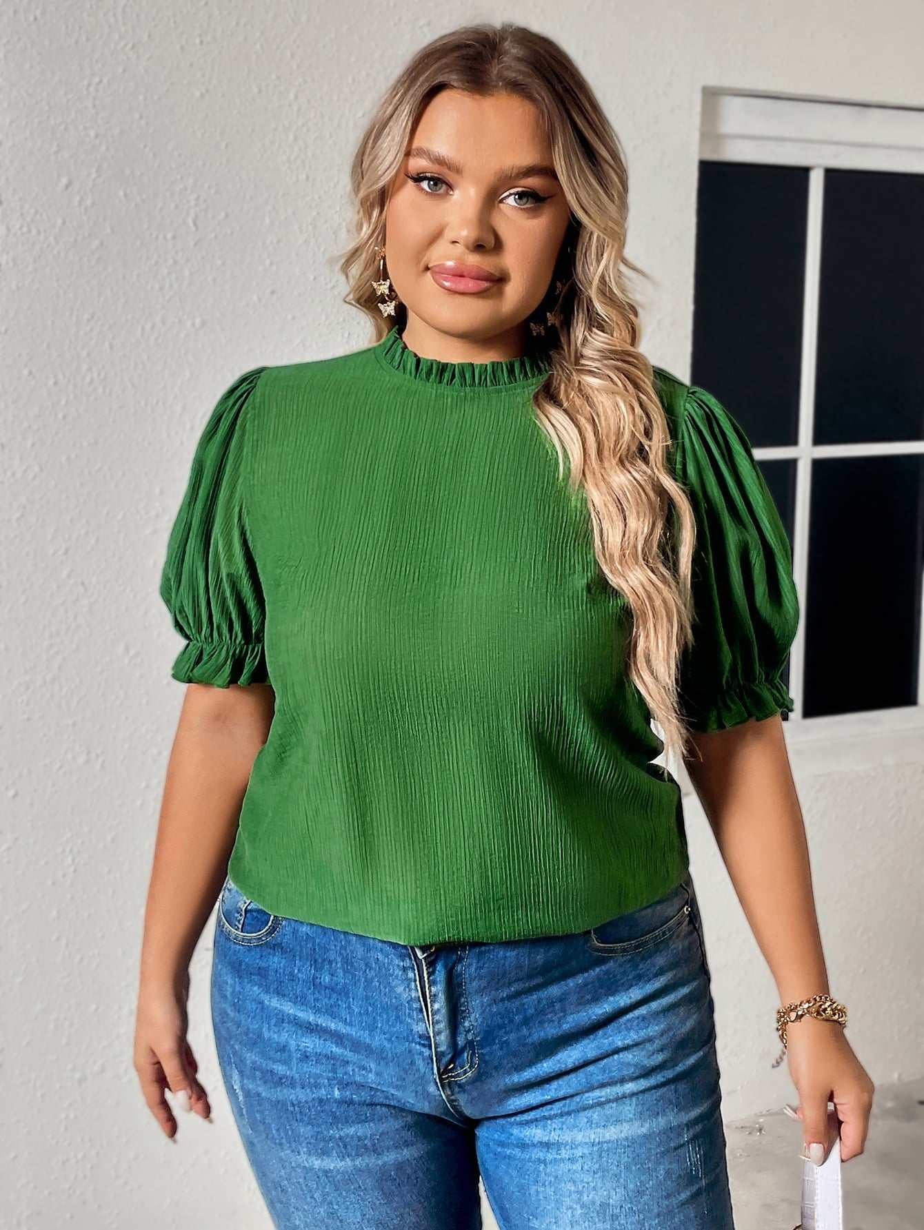 Plus size green blouse with round neck and flounce puff sleeves.