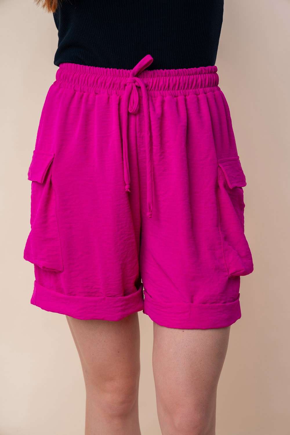 High waisted pink knit cargo shorts with drawstring and side pockets.
