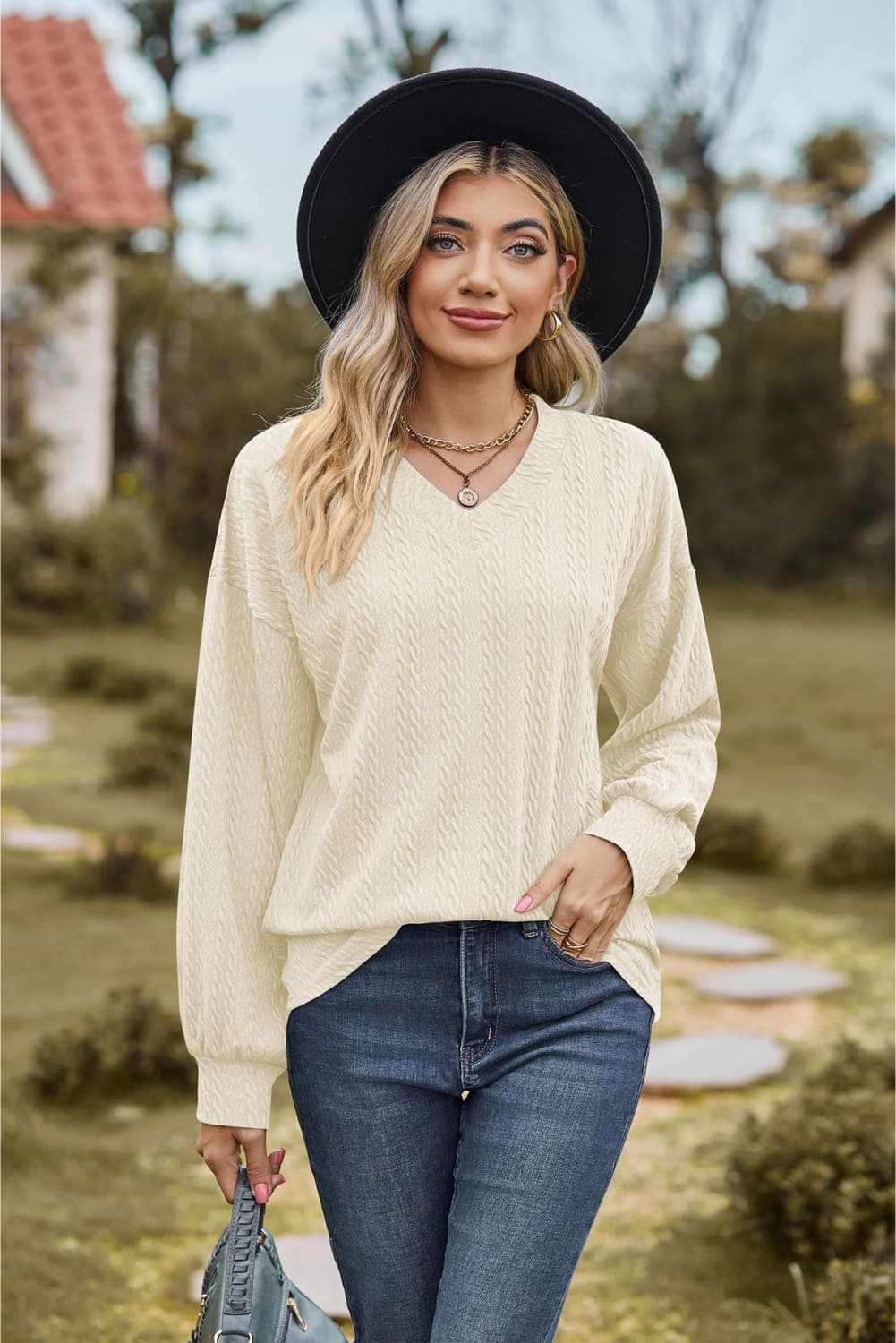 V-neck dropped shoulder blouse, solid pattern, casual style, long sleeves.