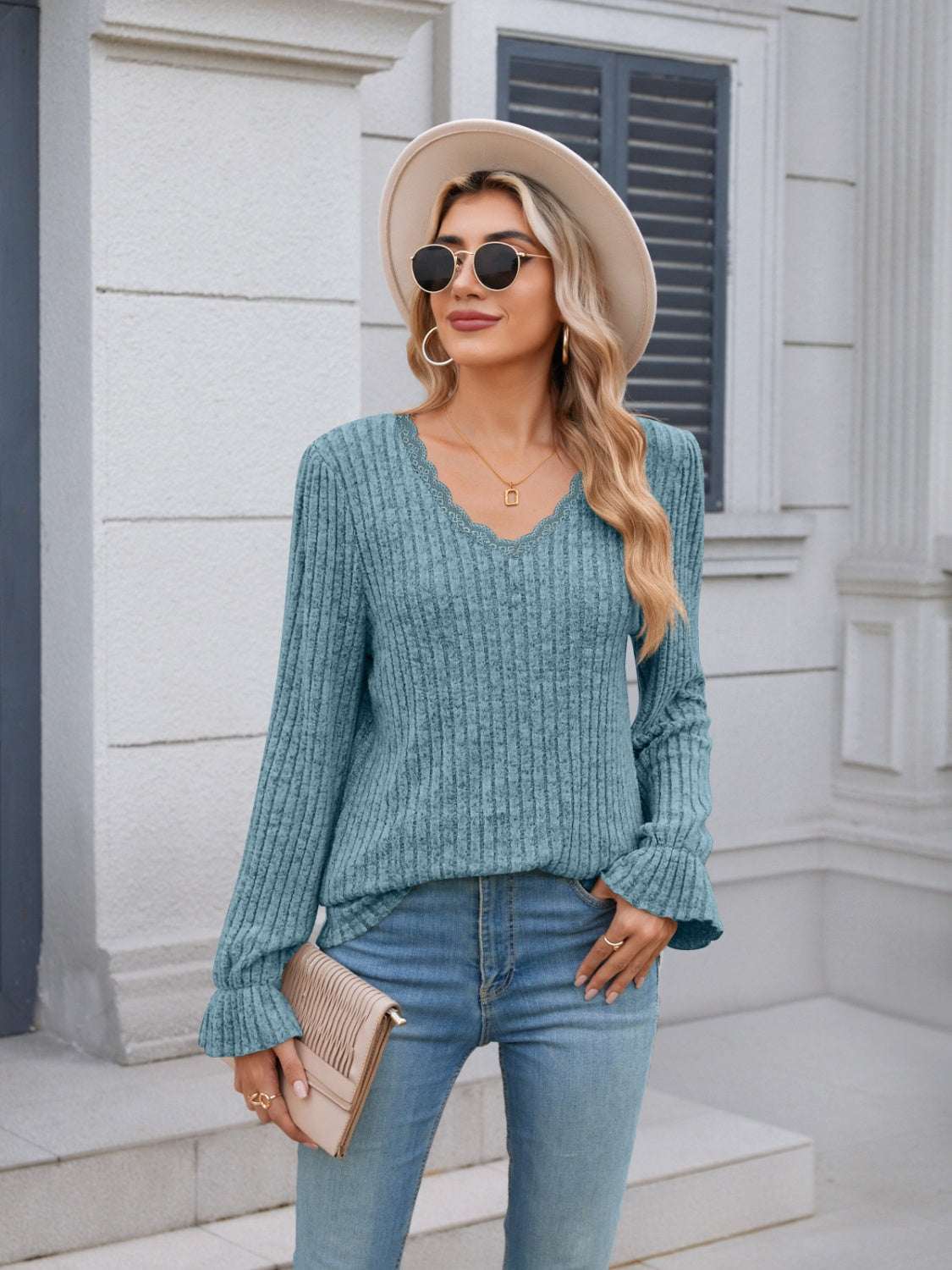 Lace detail V-neck long sleeve T-shirt with ruffled design in light blue.