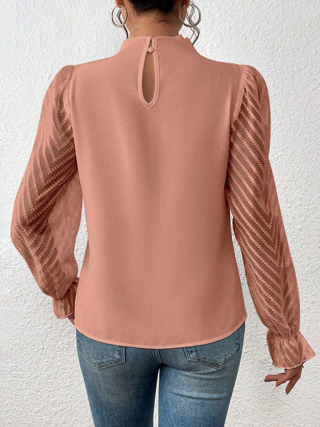 Mock neck flounce sleeve blouse with semi-sheer ruffled sleeves in peach.