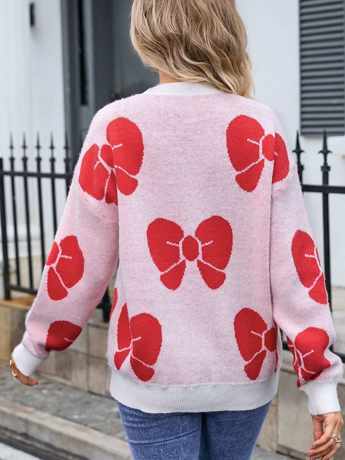 Women’s sweater with angel wings bow design, round neck, dropped shoulders, moderate stretch.