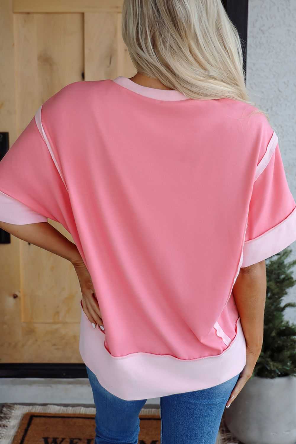 Pink short sleeve T-shirt with exposed seams and sequins, inspired by Easter egg design.