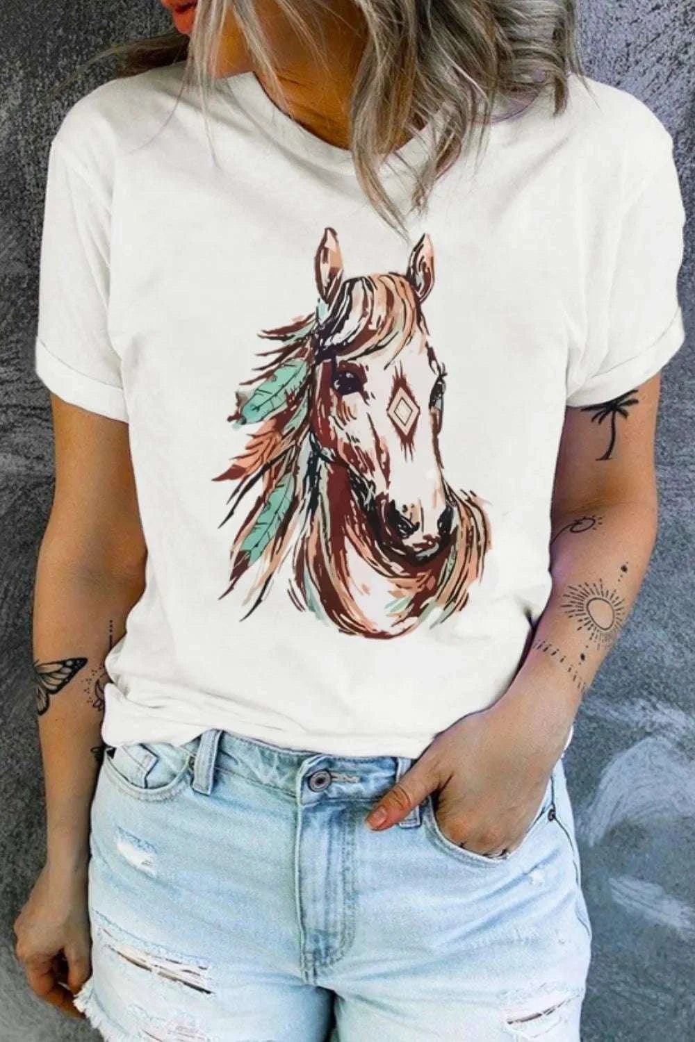 Western Aztec Horse graphic tee on a woman wearing denim shorts.