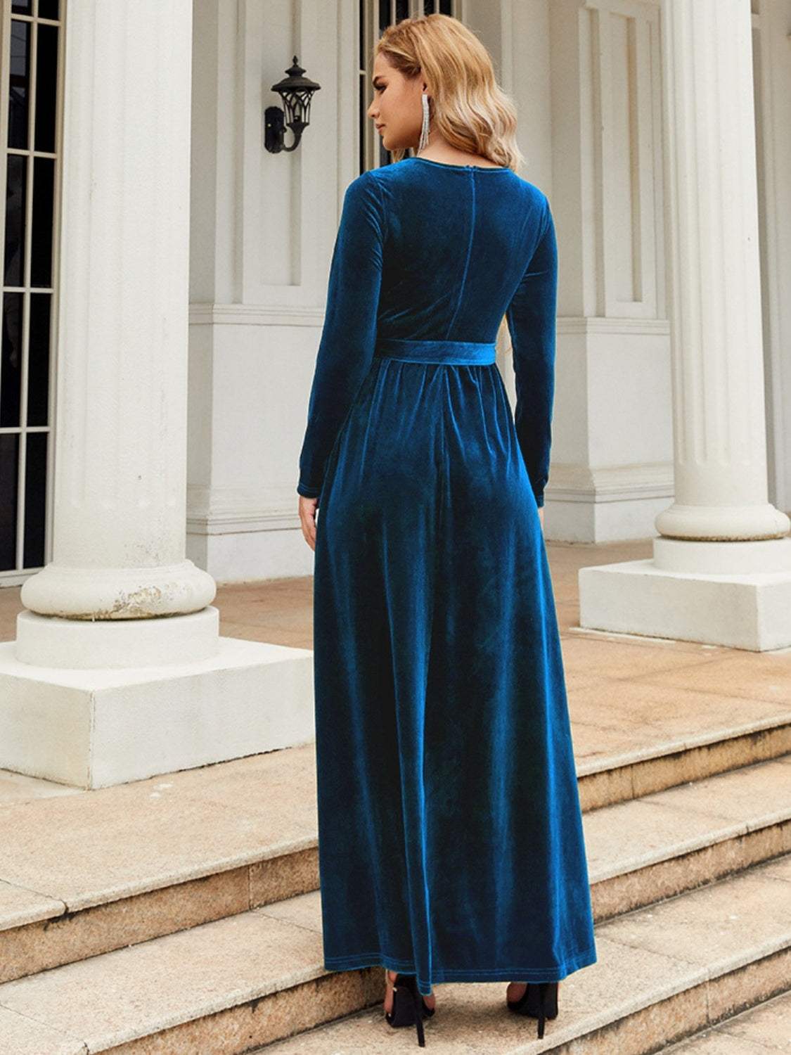 Tie front round neck long sleeve maxi dress in blue, back view, showing full length and opaque polyester fabric.