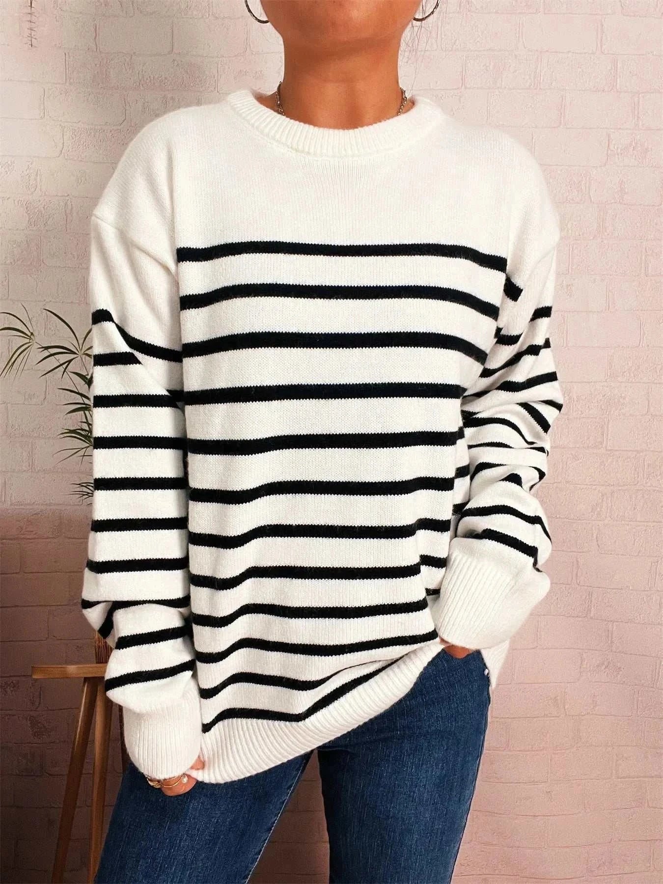 Striped round neck drop shoulder sweater in white with black horizontal stripes, slightly stretchy polyester fabric