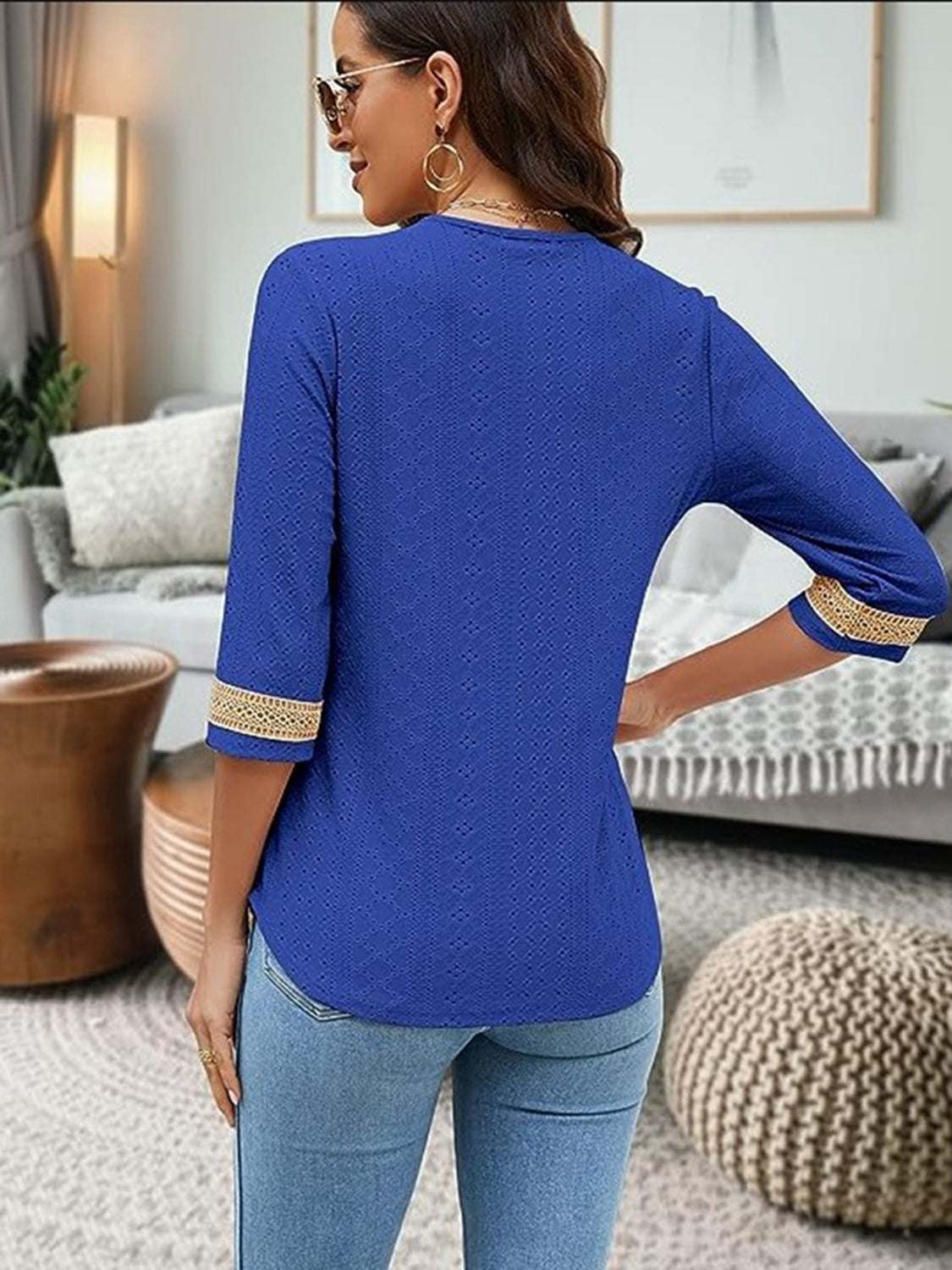 V-Neck Eyelet Blouse in blue, polyester material, opaque, with no stretch; back view.