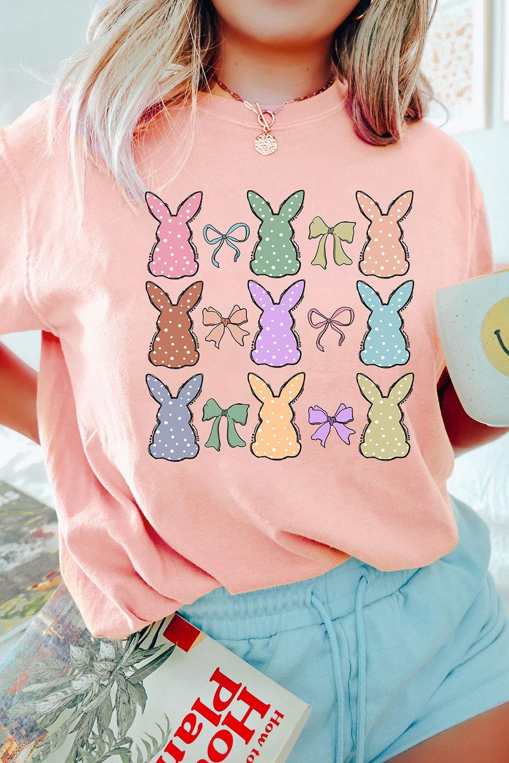 Dotty Bunny Bow Graphic Short Sleeve T-Shirt in peach with colorful bunny and bow design.